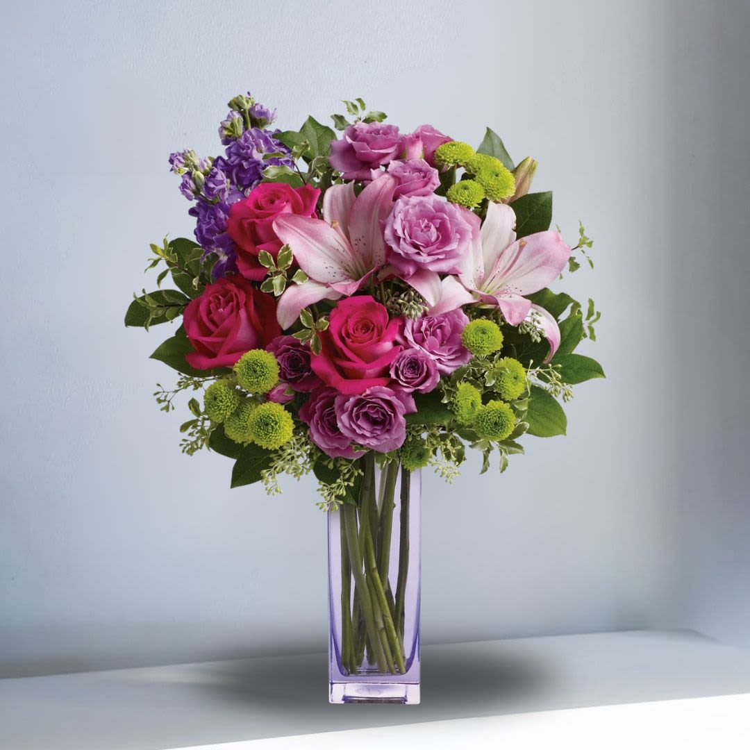 Fresh Flourish Flowers - Recipe: Mix of Lilies, Roses, Stock, and Green Buttons in a tall, vase. Seasonal: All year round Orientation: All Facing View Photo shown: Standard
