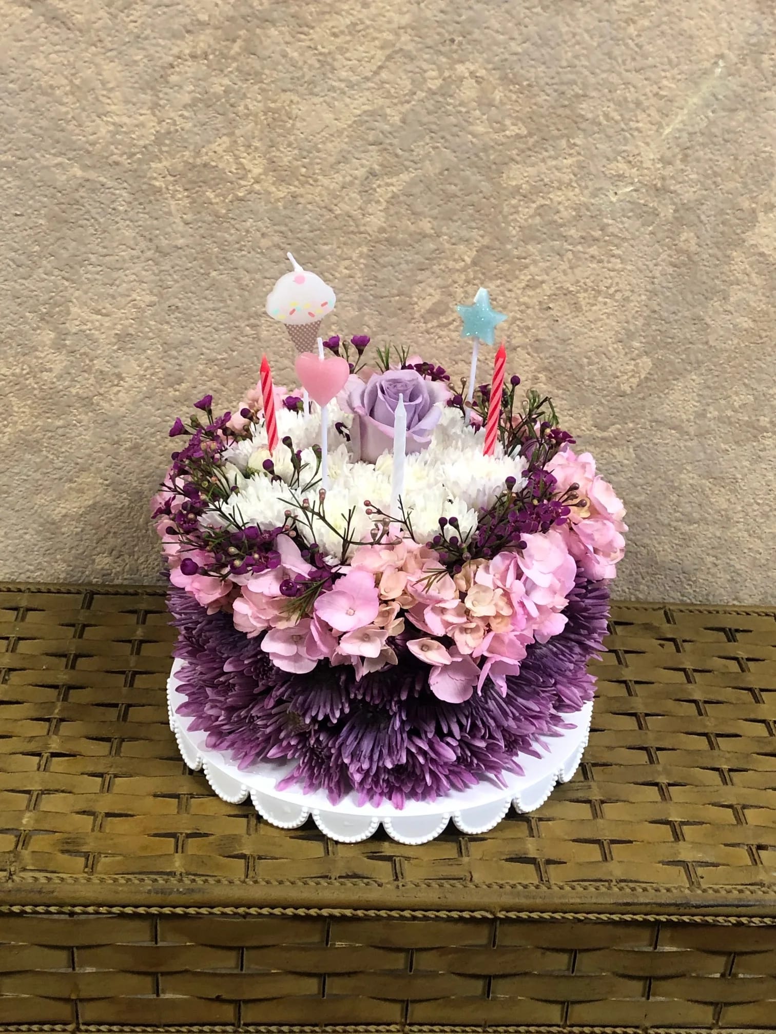 Happy Birthday Cake - Our floral birthday cake may look good enough to eat, but it's actually crafted from fresh flowers including Hydregena, roses, poms, waxflower and candles.