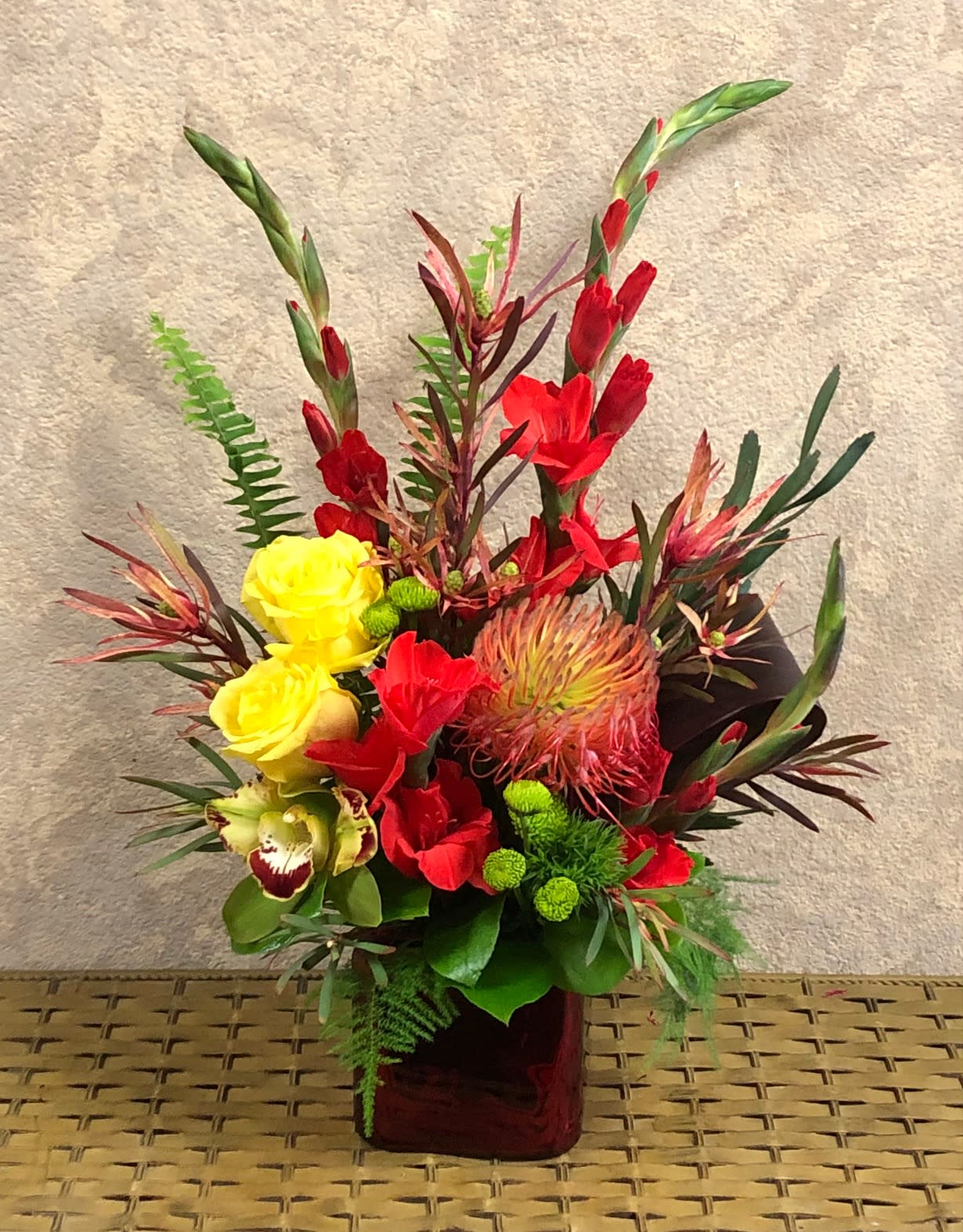 Thank You Firefighters - This arrangement is perfect for firemen, retirement or funeral. ype of Flowers: Red Gladiolas, Yellow Roses, Green Cymbidium Orchids, Red Pin Cushion Protea, Green Buttons, Dianthus barbatus Availability: All year round Substitute Available: Yes Design View: Symmetric Front Facing View Photo shown: Standard 