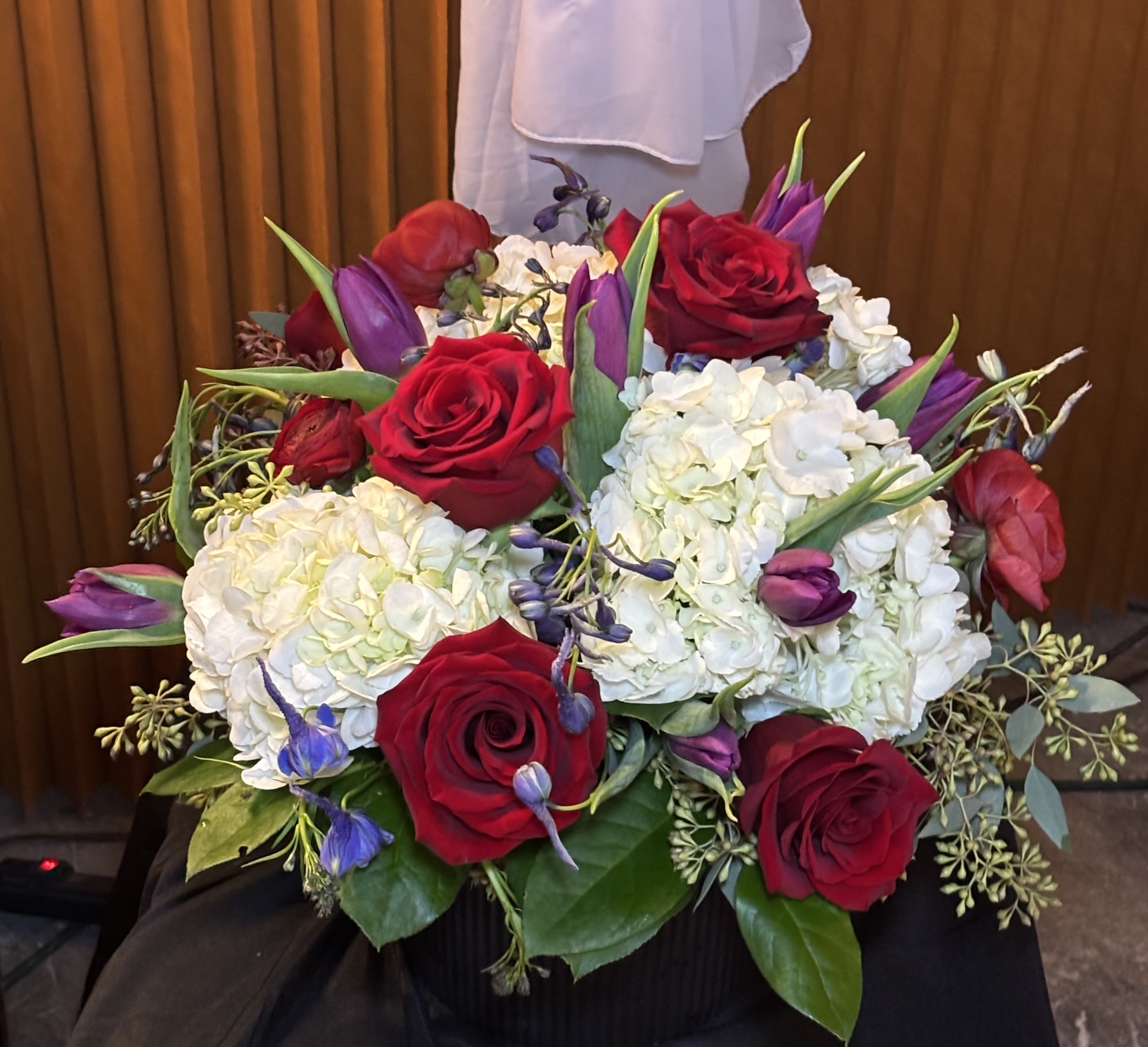 Bouquet of red roses, white hydrangeas, and purple tulips