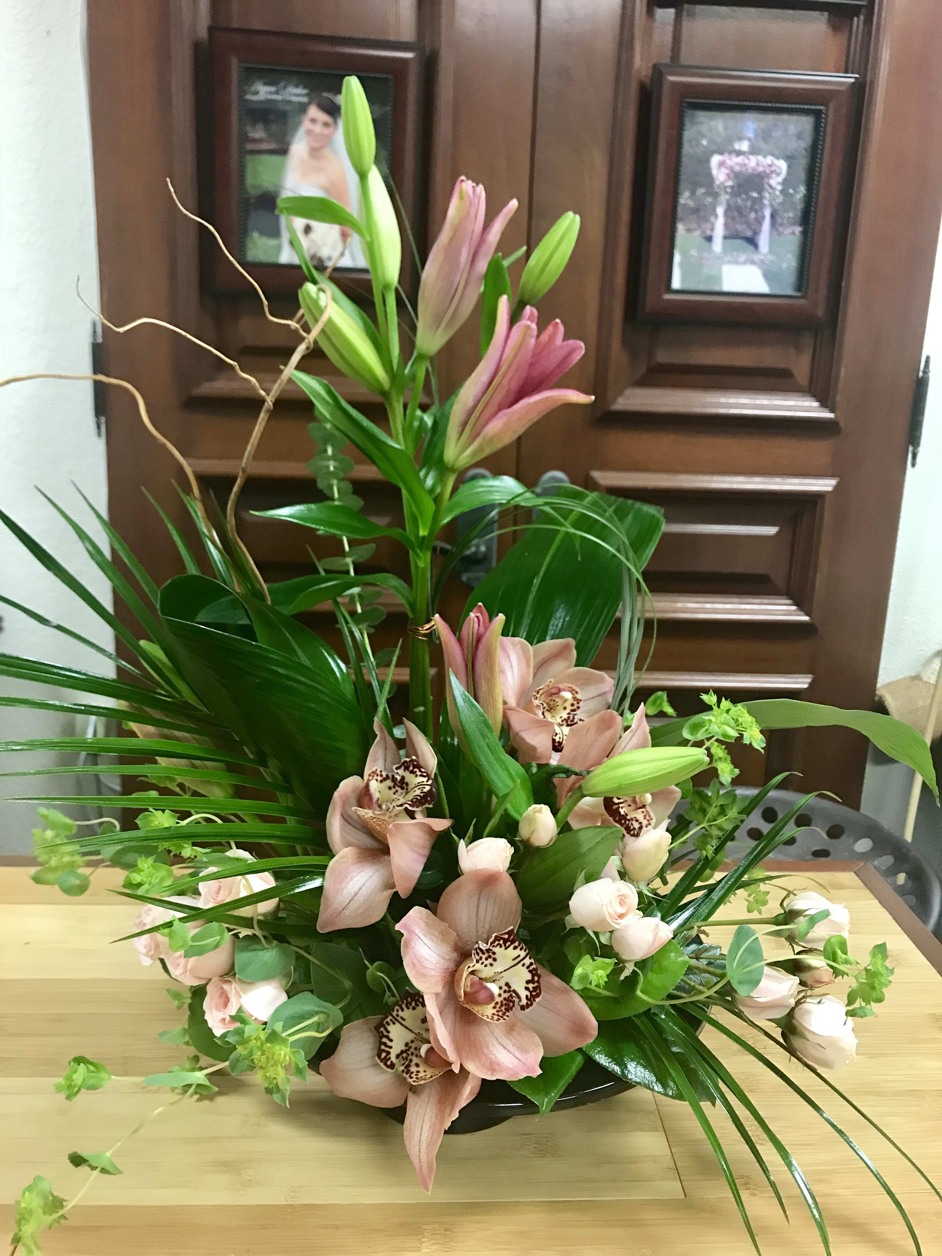 Venice  - Type of Flowers: Cymbidium Orchids, Asiatic Lilies, Spray Roses with greens and branches in a plate.