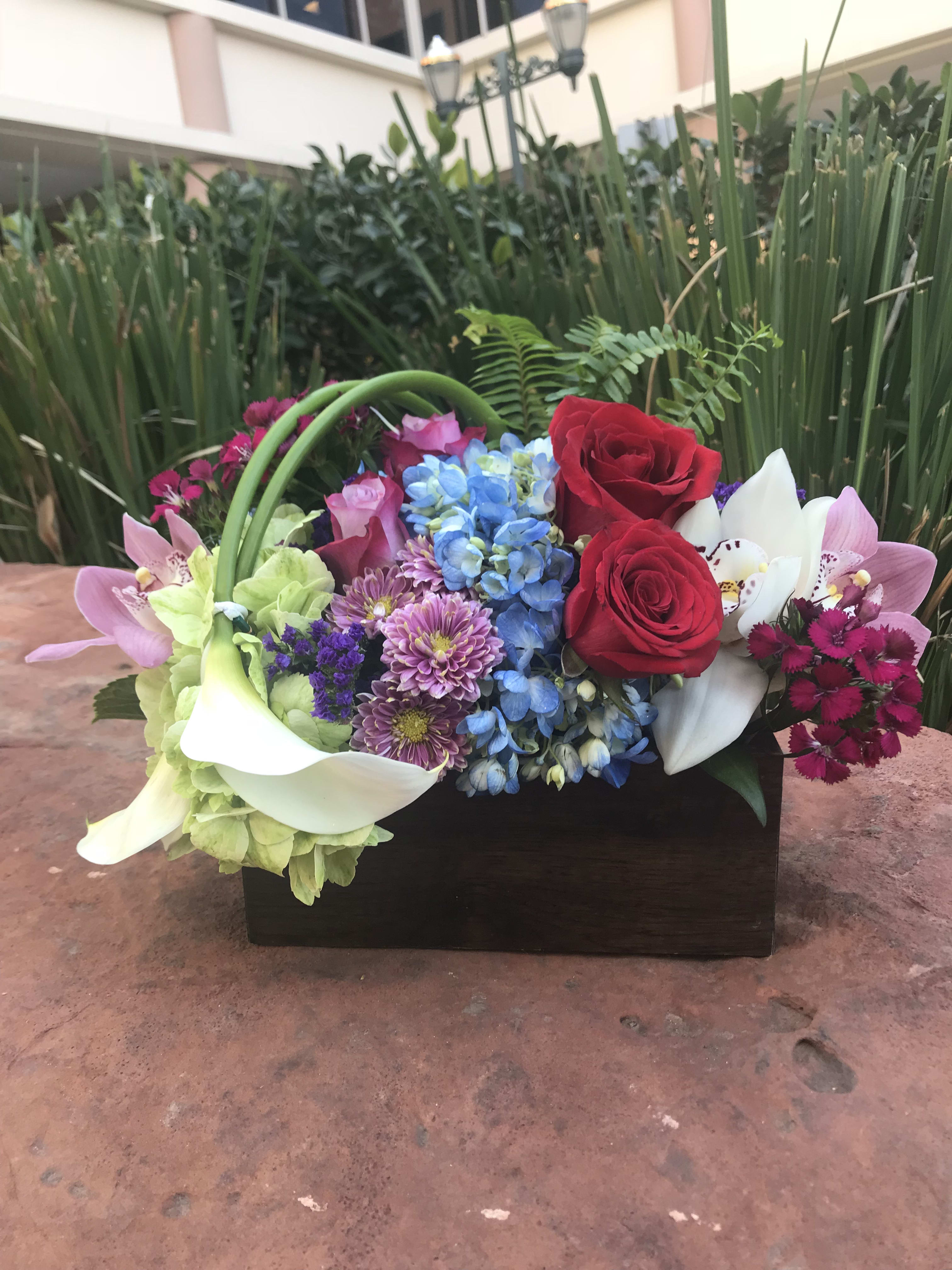 New York, New York - Type of Flowers: Cymbidium Orchid, Hydrangeas, Calla Lilies, Roses, and more in a 4” x 6” long, wooden box. Availability: All year round Substitute Available: Yes Design View: Symmetric Front Facing View Photo shown: Regular