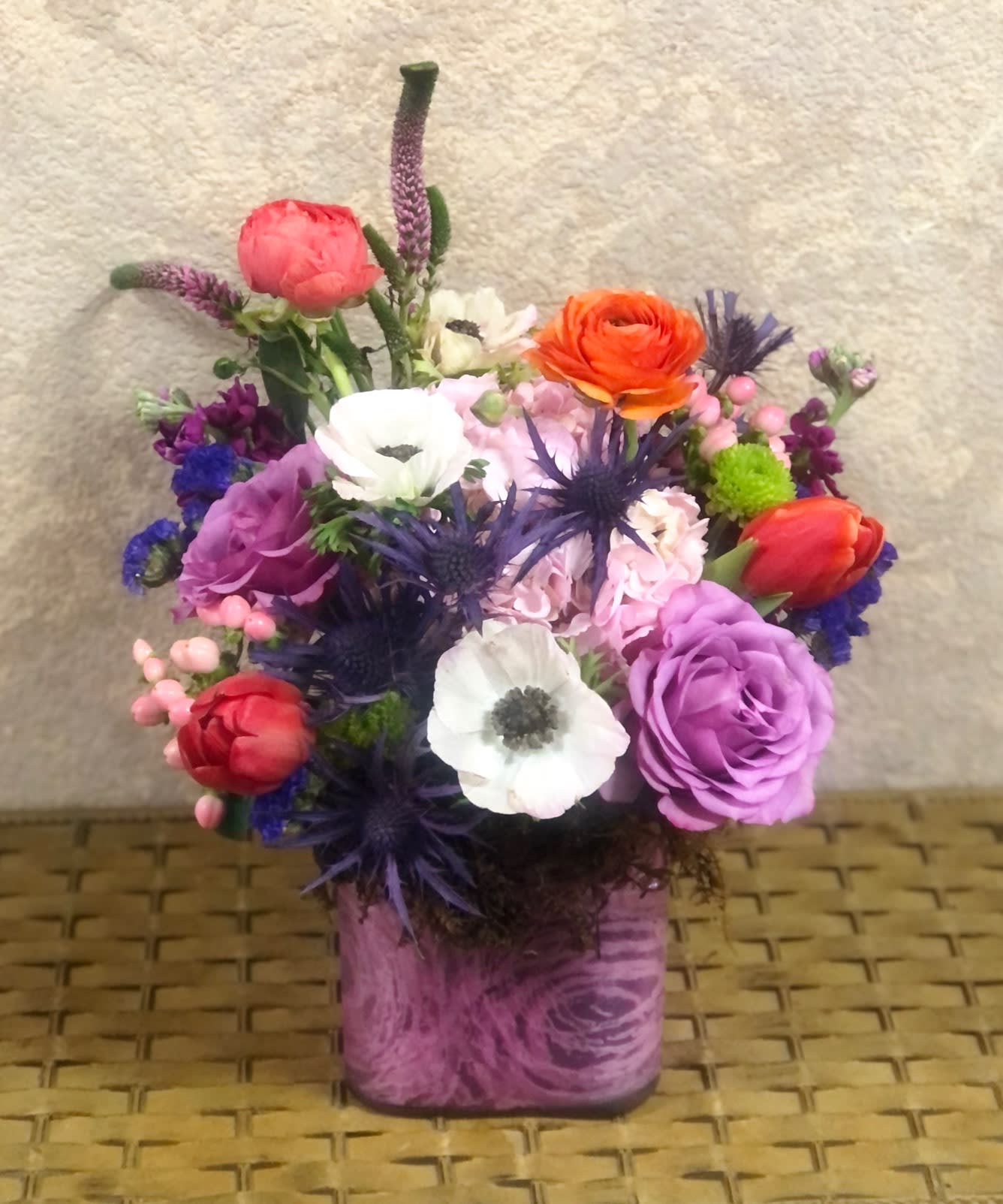Santa Clarita  - Bright and Cheerful with roses, anemone, ranunculus, tulips, stock all in a pink cube vase.