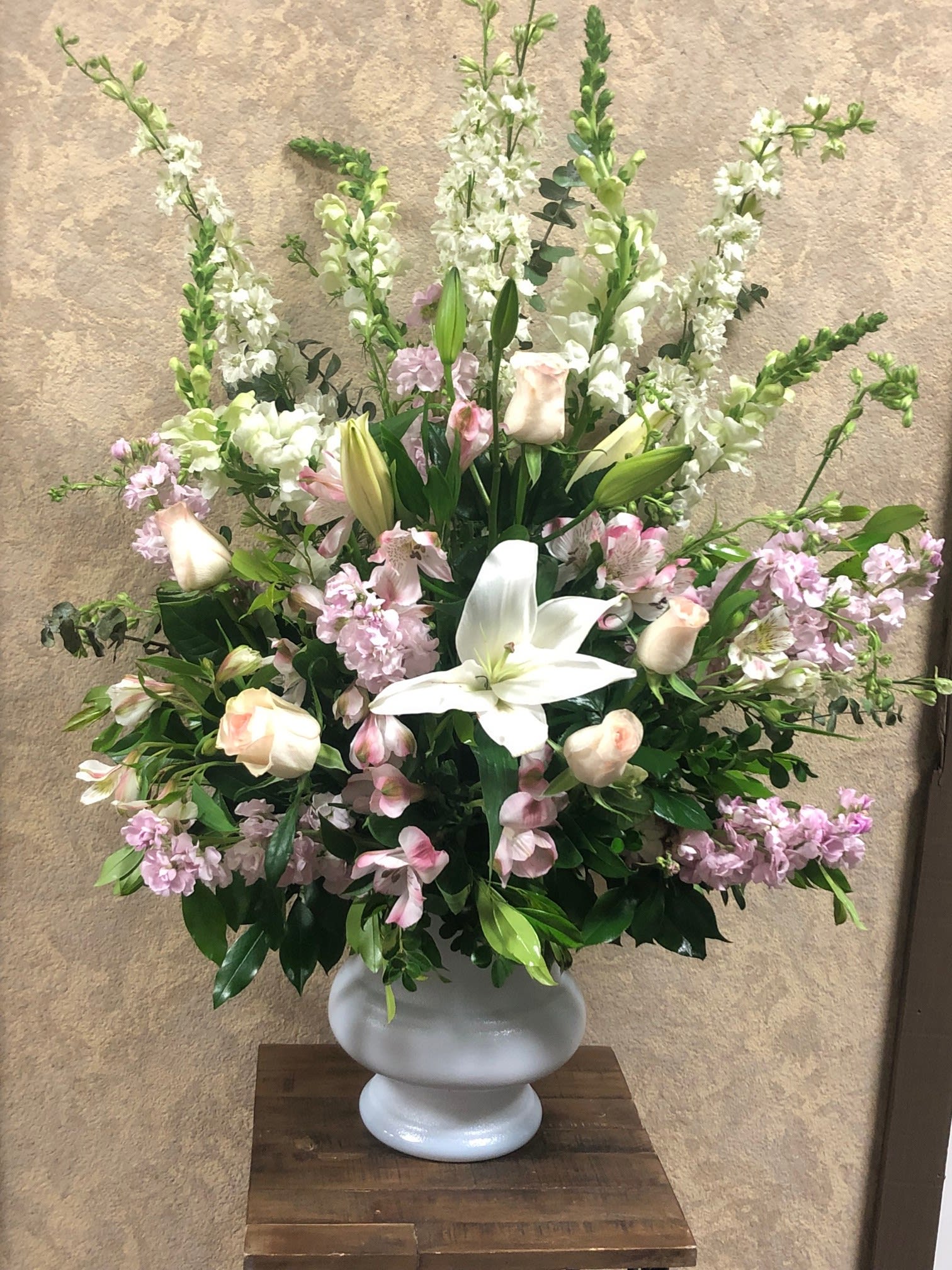 Love and Cherish - White snapdragons, blush roses, white oriental lilies, blush stock, blush alstroemerias, in a plastic container.