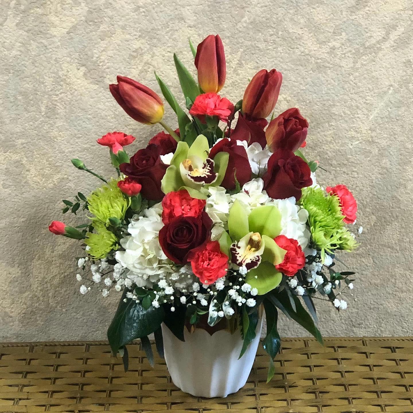 Life is Sweeter with you in it - Have you ever thought how much life is sweeter with your close ones in it?  Type of Flowers: Red Roses, White Hydrangeas, Red Tulips, Green Cymbidium Orchids, Red Mini Carnations, Green Buttons and Baby Breathe in a white ceramic vase. Availability: All year round Substitute Available: Yes Design View: All Facing View Photo shown: Regular