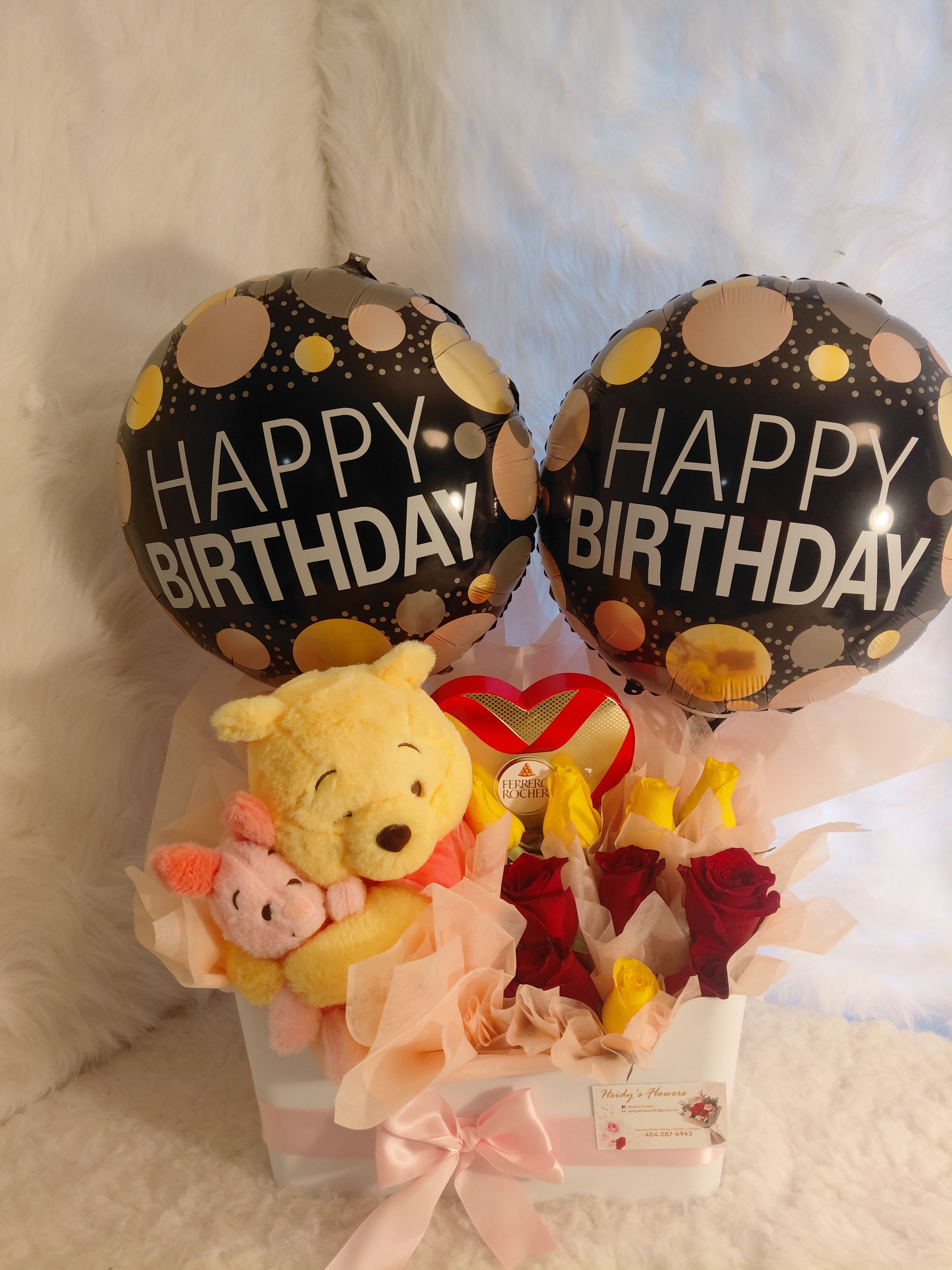 Winniepooh arrangement  - A Winnie the Pooh-themed gift set with roses, balloons, and chocolates. The balloons can be personalized. A beautiful and delicate arrangement.