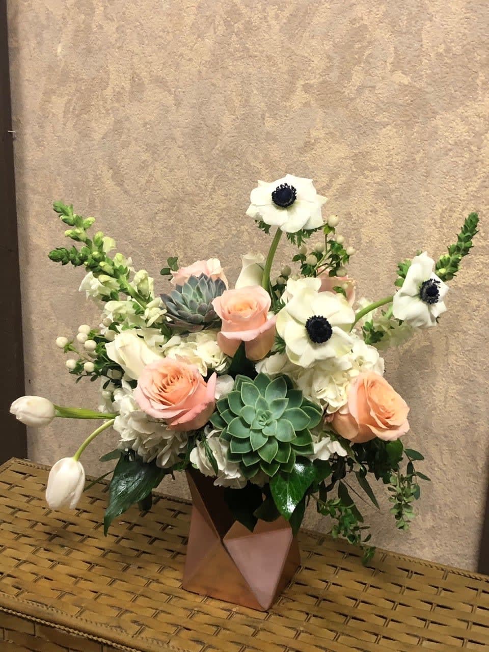 Torcello, Veneto - Type of Flowers: White Snapdragons, Anemones, if anemones are out seasonal, you will get peonies.  blush Pink Roses, White Hydrangeas, White Tulips, White Hypericum Berries and Succulents in a rose pink ceramic vase. Availability: Anenomes- Winter (Nov-March), end of spring - ( April) Substitute Available: Yes Design View: All Facing View Photo shown: Regular