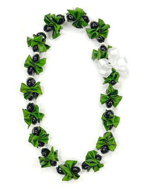 Green and black beaded lei with a white ribbon bow
