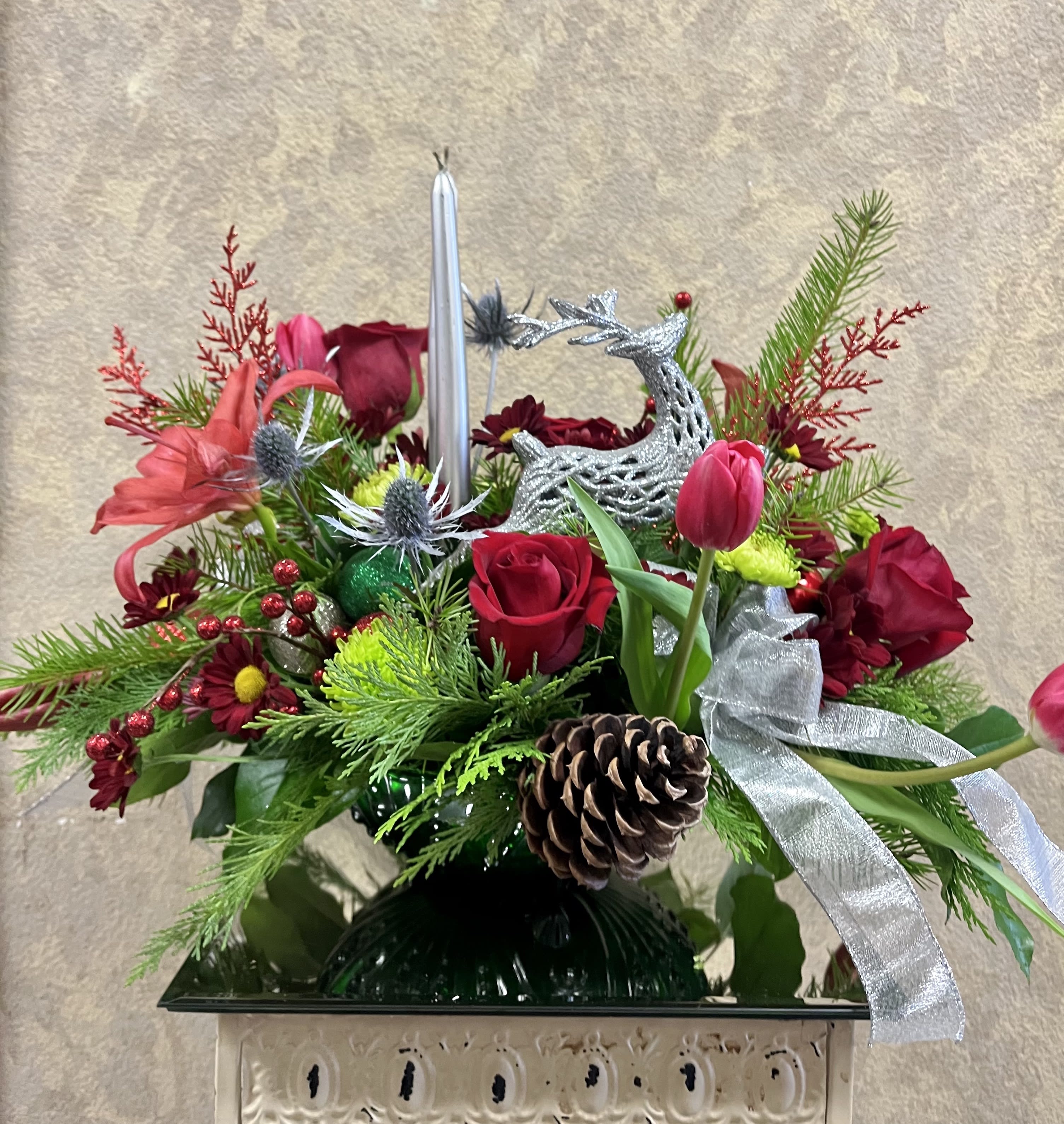 Limited Oh, deer it's Christmas! - This limited product includes a Vintage, green crystal vase.  Type of Flowers: Red Roses, Red Lilies, Red Daisies, Red Tulips. Green Buttons, Christmas accents and pine cones in a vintage green vase with candles and bow. Availability: All year round Design View: Symmetric Front Facing View Photo shown: Regular 