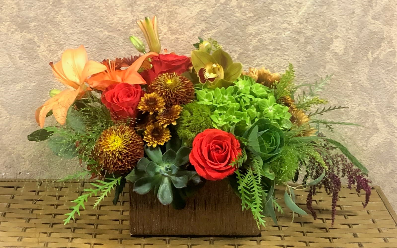 Munich, Germany - Type of Flowers: Green Hydrangeas, Green Cymbidium Orchids, Brown Dahlias, Orange Roses, Chrysanthemums, and cabbage in a short, ceramic vase. Availability: All year round Substitute Available: Yes Design View: All Facing View Photo shown: Regular 
