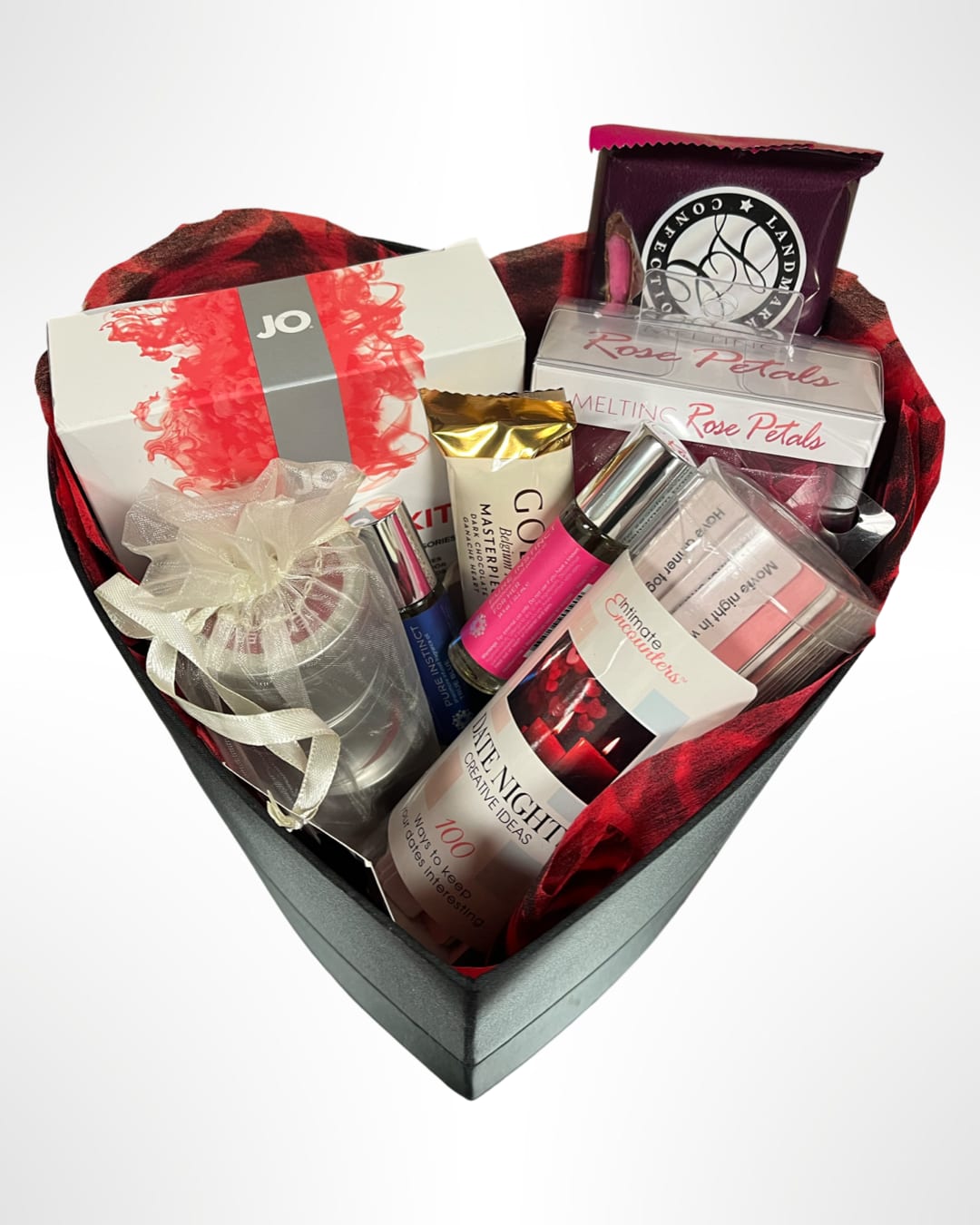 The Weekender Date Night Box - This couple date night basket will deepen your romance in various ways. This kit includes: Jo all-in-one massage Glide Kit Warming Silicone 10 oz. Pure instinct pheromone fragrance oil for him and her 10.2 ml. Made in the USA Hemp Seed 3-in-1 massage candles trio: Pillow Talk, Between the Sheets, Mattress Mamo 2 oz. Made in the USA Melting Rose Petals. 100 Creative Date Night Ideas. Dark Chocolate Candy Bars. In a heart shaped box wrapped in a black satin ribbon.