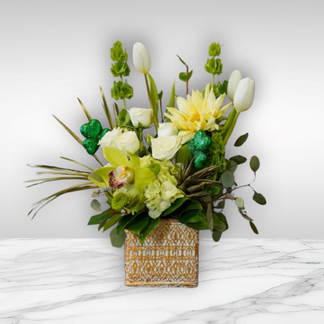 Pot of Gold  - Type of Flowers: Bells of Ireland, White Tulips, Yellow Sunflower, Green Cymbidium Orchid, White Spray Roses, Green Hydrangea, Green Buttons and Green succulent in a short, golden pattern ceramic vase. Availability: All year round Design View: Symmetric Front Facing View Photo shown: Standard 