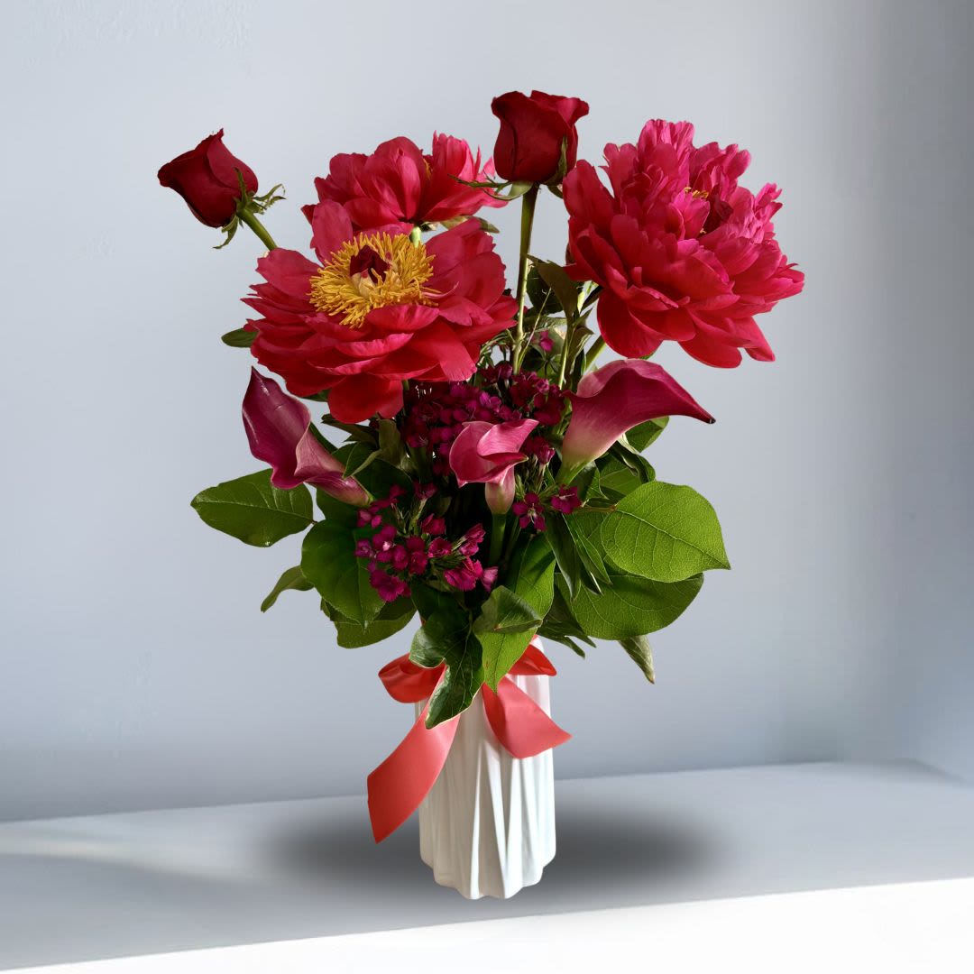 High end Garden Peonies - Peonies are beloved for their lush, cloud-like blooms, soft fragrance, and timeless elegance. Known as one of the most luxurious flowers of spring, each stem opens beautifully over time, creating a full and romantic garden-inspired arrangement. Their delicate layered petals and limited seasonal availability make peonies especially treasured for celebrations, meaningful gifts, and heartfelt moments. Elegant, feminine, and effortlessly stunning, peonies bring beauty and joy to every space they enter. With added calla lilies this give a more luxurious feel.