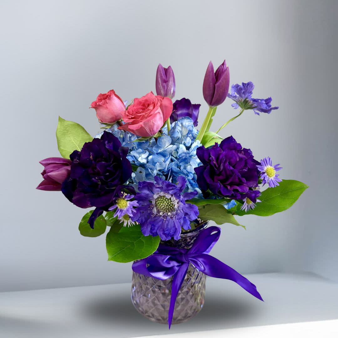 Velvet Scabiosa - Seasonal Purple Scabiosa, Purple Lisianthus, Hydrangae, Tulips, Spray Roses and more in a purple vase.
