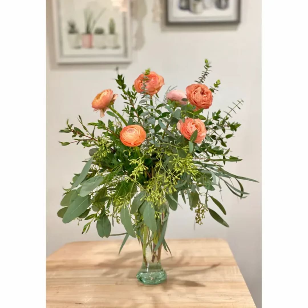Peach ranunculus bouquet in a clear glass vase