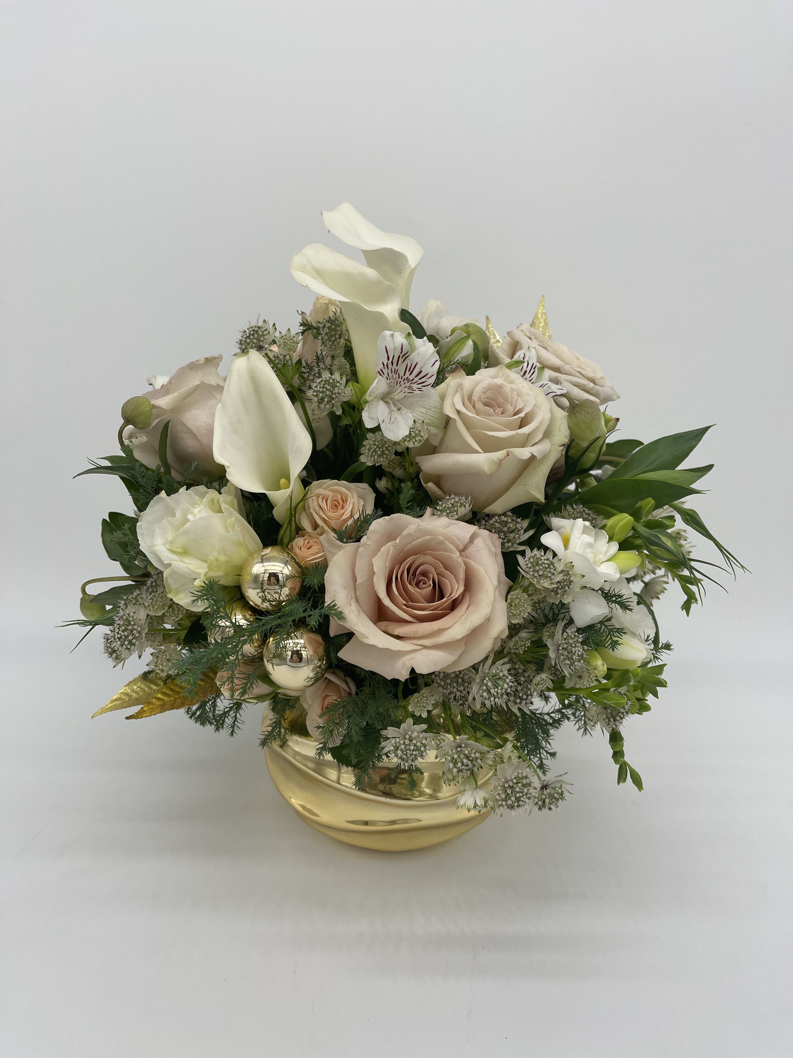 Low gold bowl arrangement with blush roses, white calla lilies, and mixed white flowers with gold accents.