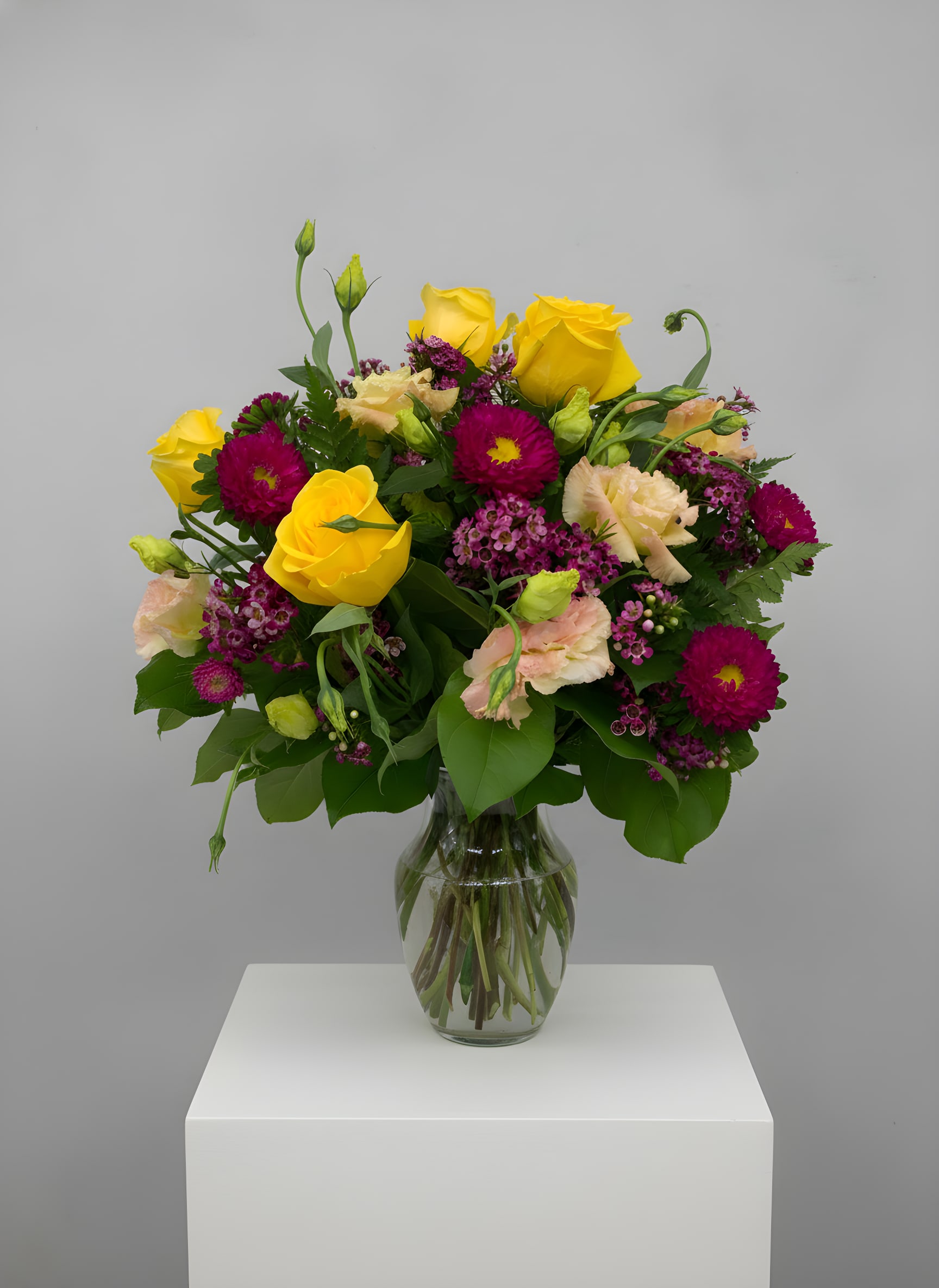 LF126 - Georgie Girl - A lovely arrangement with yellow roses accented with other seasonal flowers.