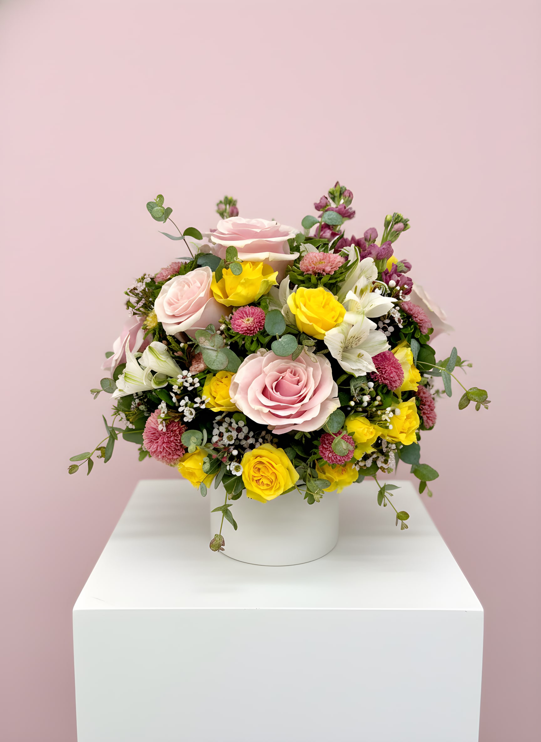 LF407  How Sweet It Is - Beautiful as they get and, "How Sweet It Is".  This arrangement says elegance and class.  Half dozen pink roses arranged with lavender stock, yellow spray roses, pink asters and white alstroemeria.  This arrangement sits pretty, all the way around,  in a white ceramic vase.     Orientation- All Around Approx Dim.  12"H x 10"W x 8" D