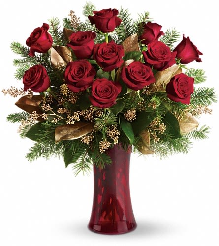 Arrangement of red roses with evergreen branches and gold accents in a red glass vase
