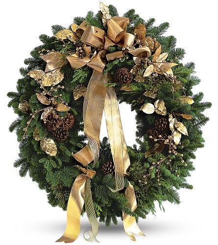 Evergreen wreath decorated with gold ribbon, pinecones, and metallic gold leaves and berries.