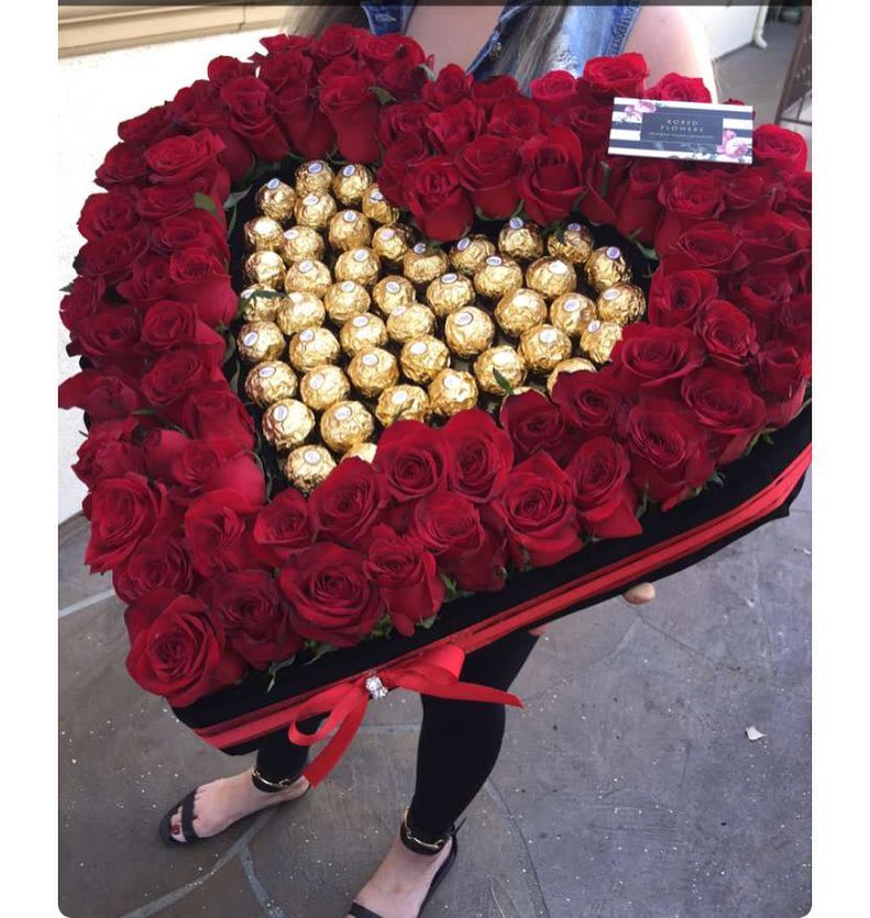 Heart-shaped box of red roses with gold-wrapped chocolates