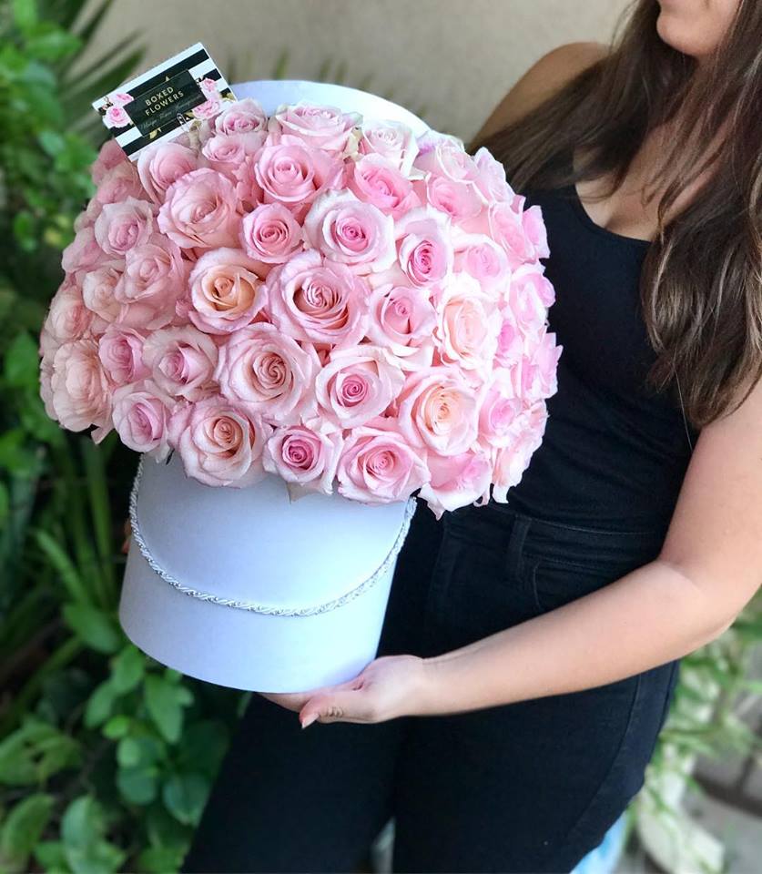 Large bouquet of pink roses in a white hat box