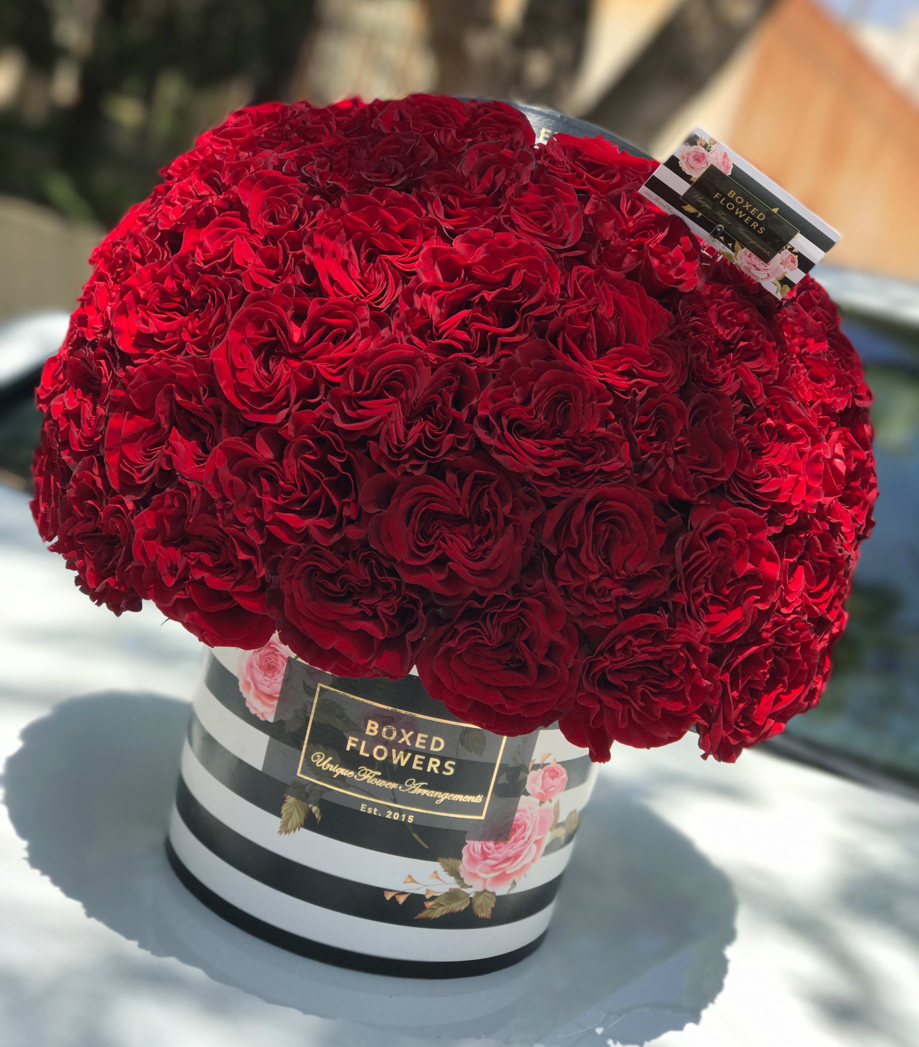 Ruffled Red rose Signature Logo Box - This seductive signature box filled with over 50 ruffled "Hearts" red roses is sure to blow away even the pickiest customers