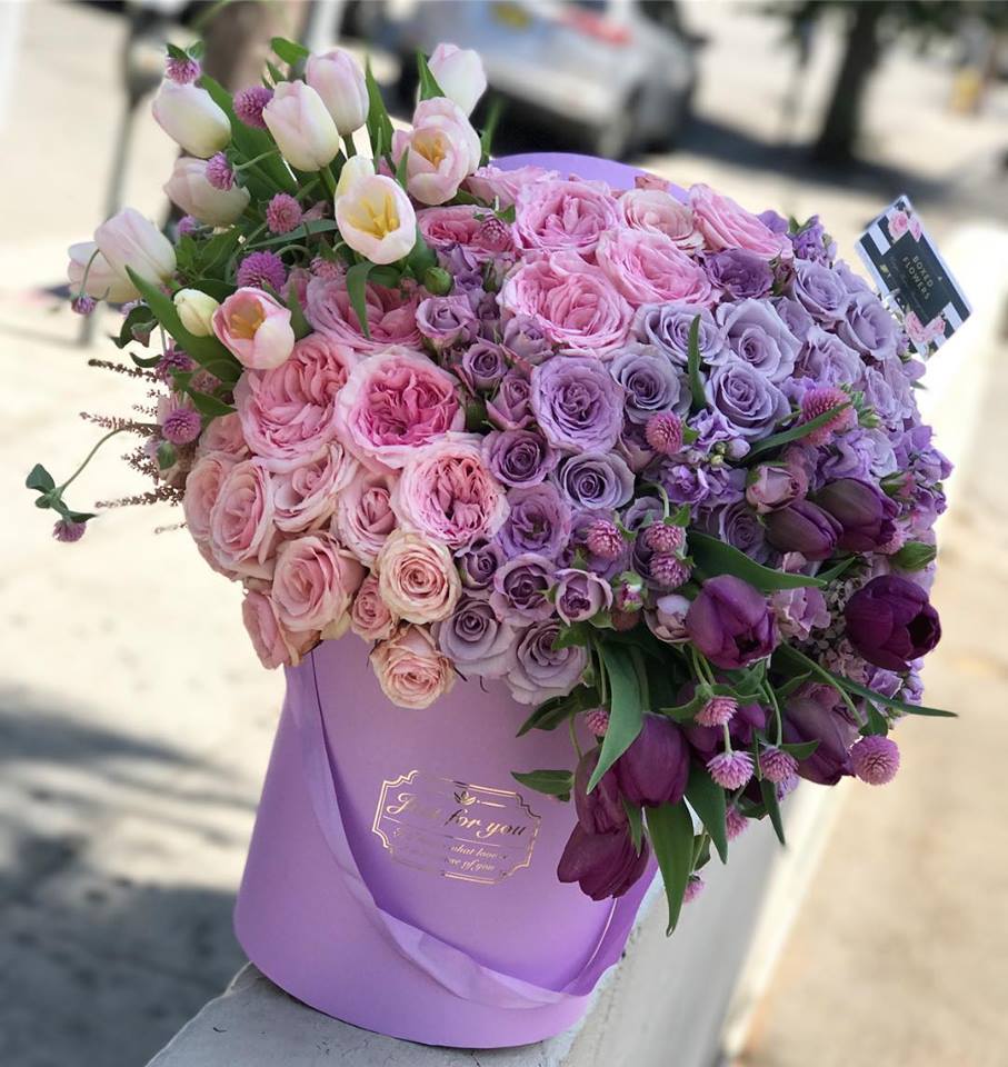 Lavender hatbox arrangement of pink and purple roses with tulips
