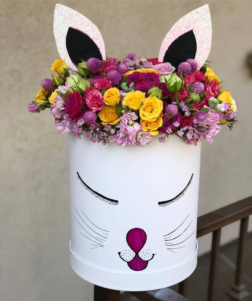 Flower arrangement in a white cat-face box with pink ears
