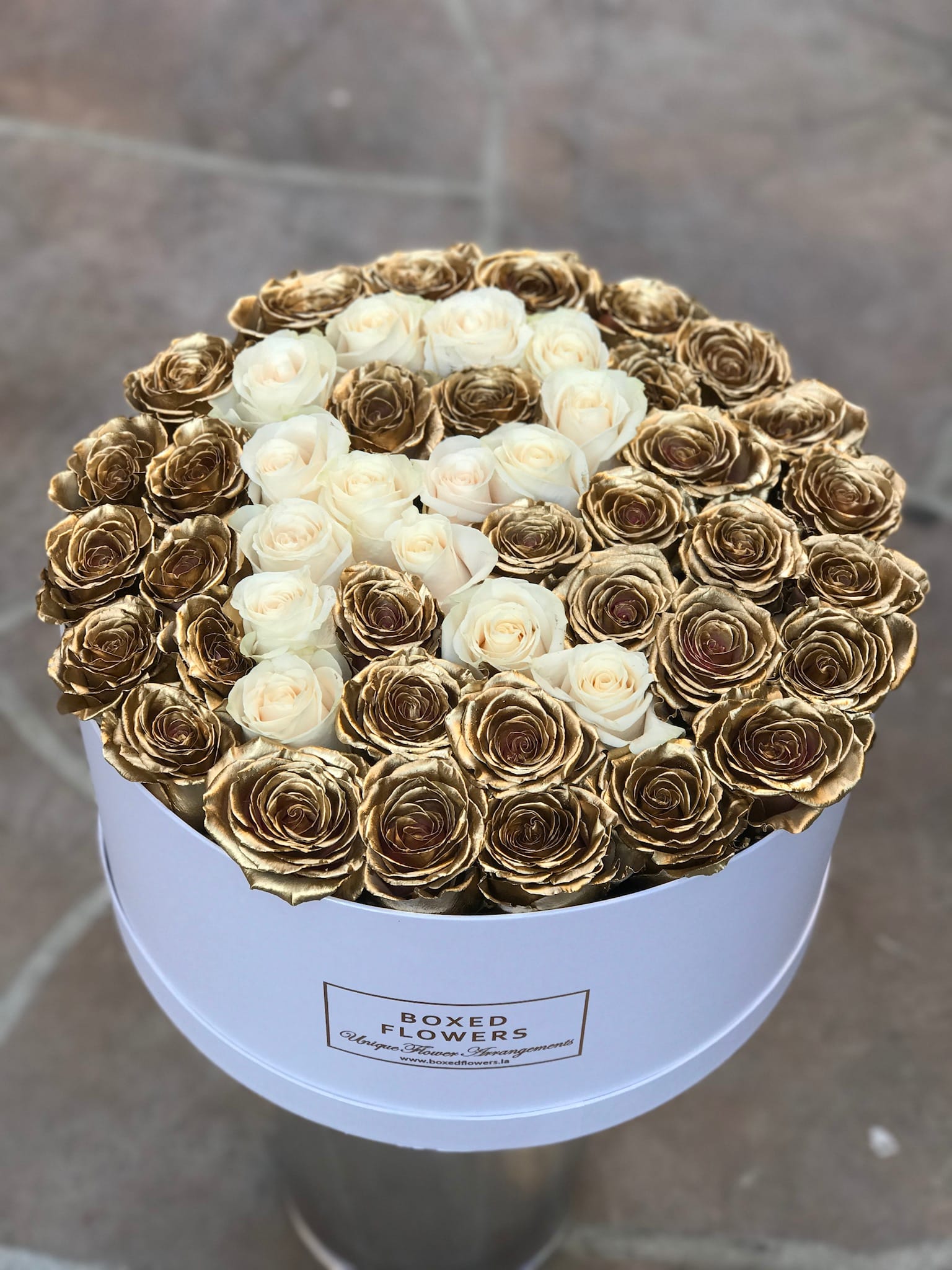 Round box of white and gold roses