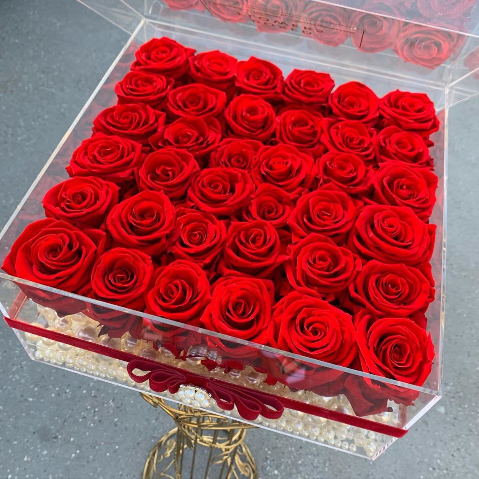 Box of red roses in a clear acrylic container