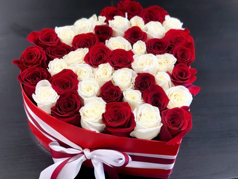 Heart-shaped box filled with red and white roses