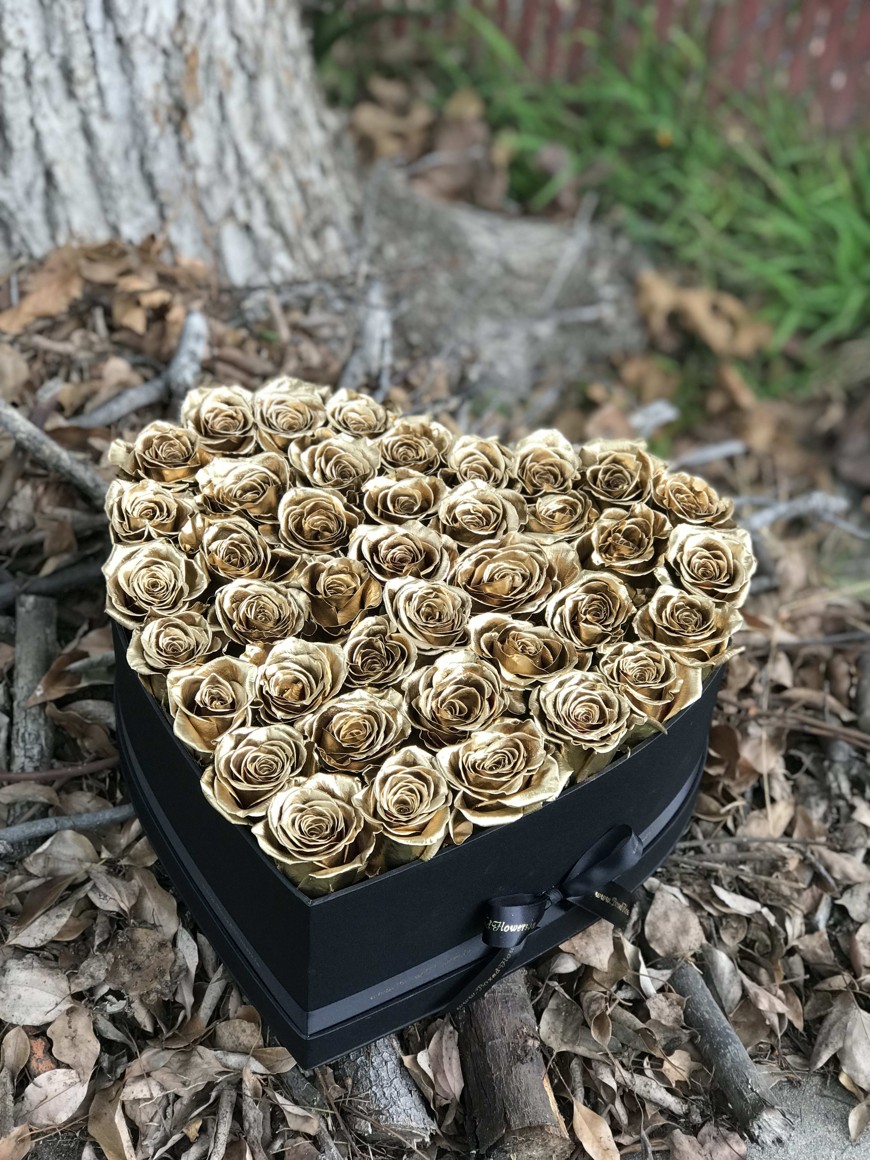 Heart-shaped box filled with gold roses