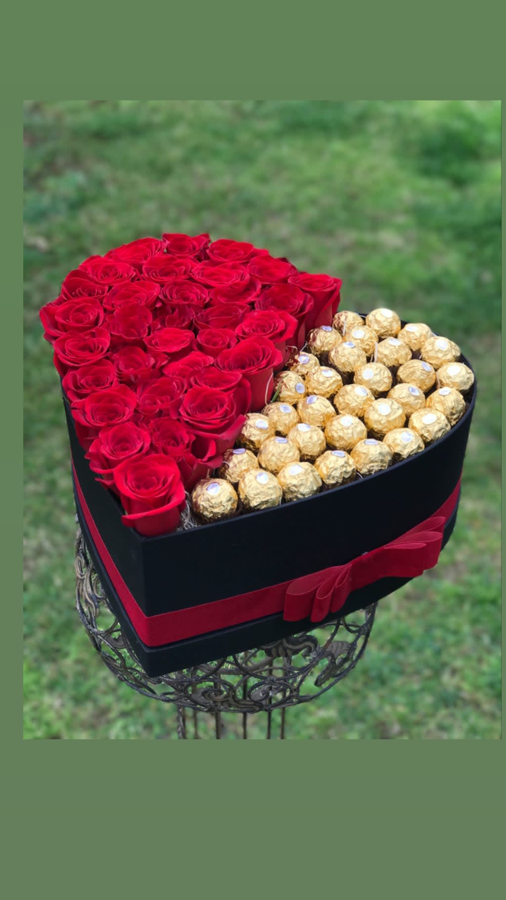 Heart-shaped box of red roses and gold-wrapped chocolates