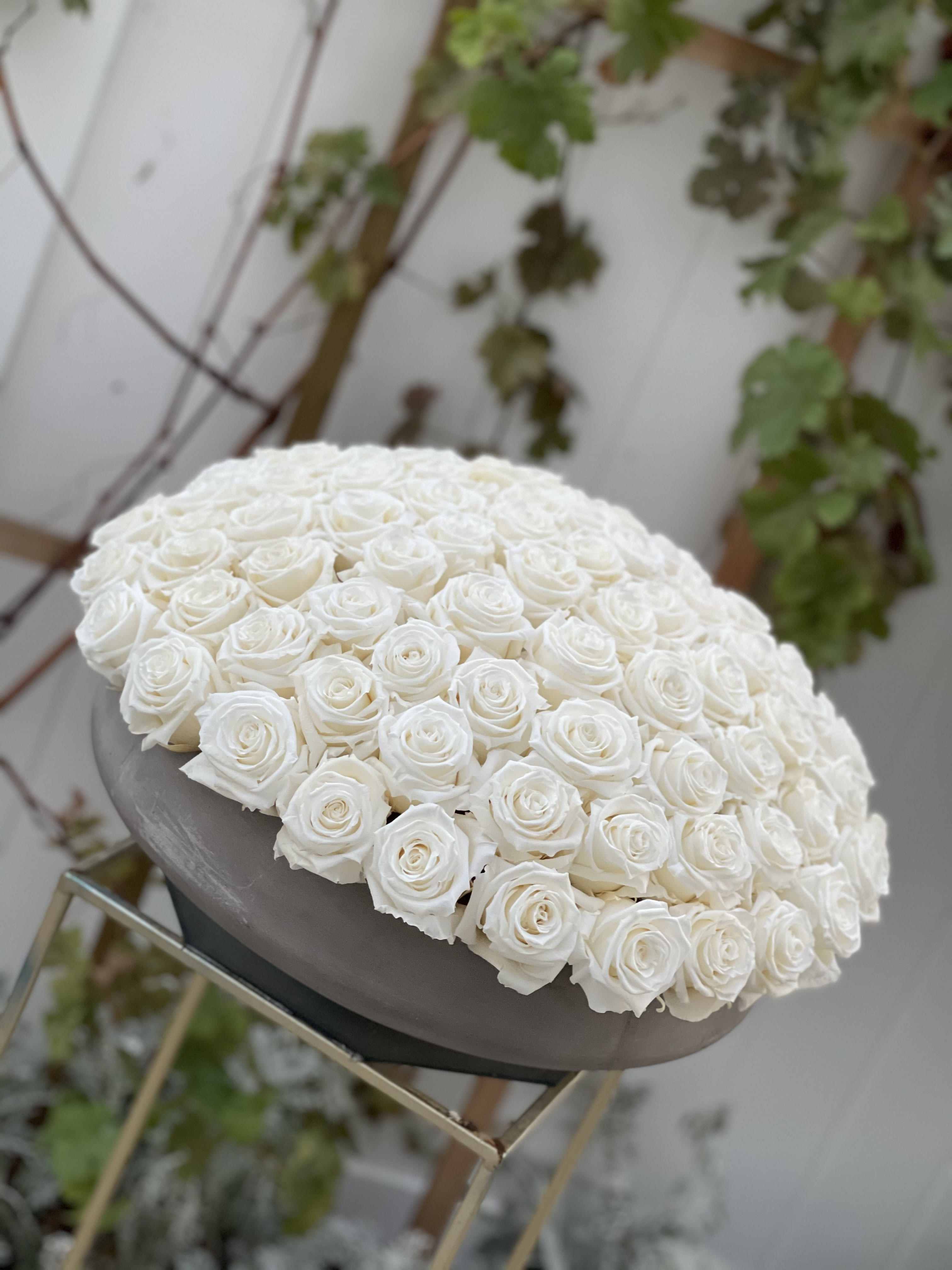 Large dome of white roses on a pedestal stand