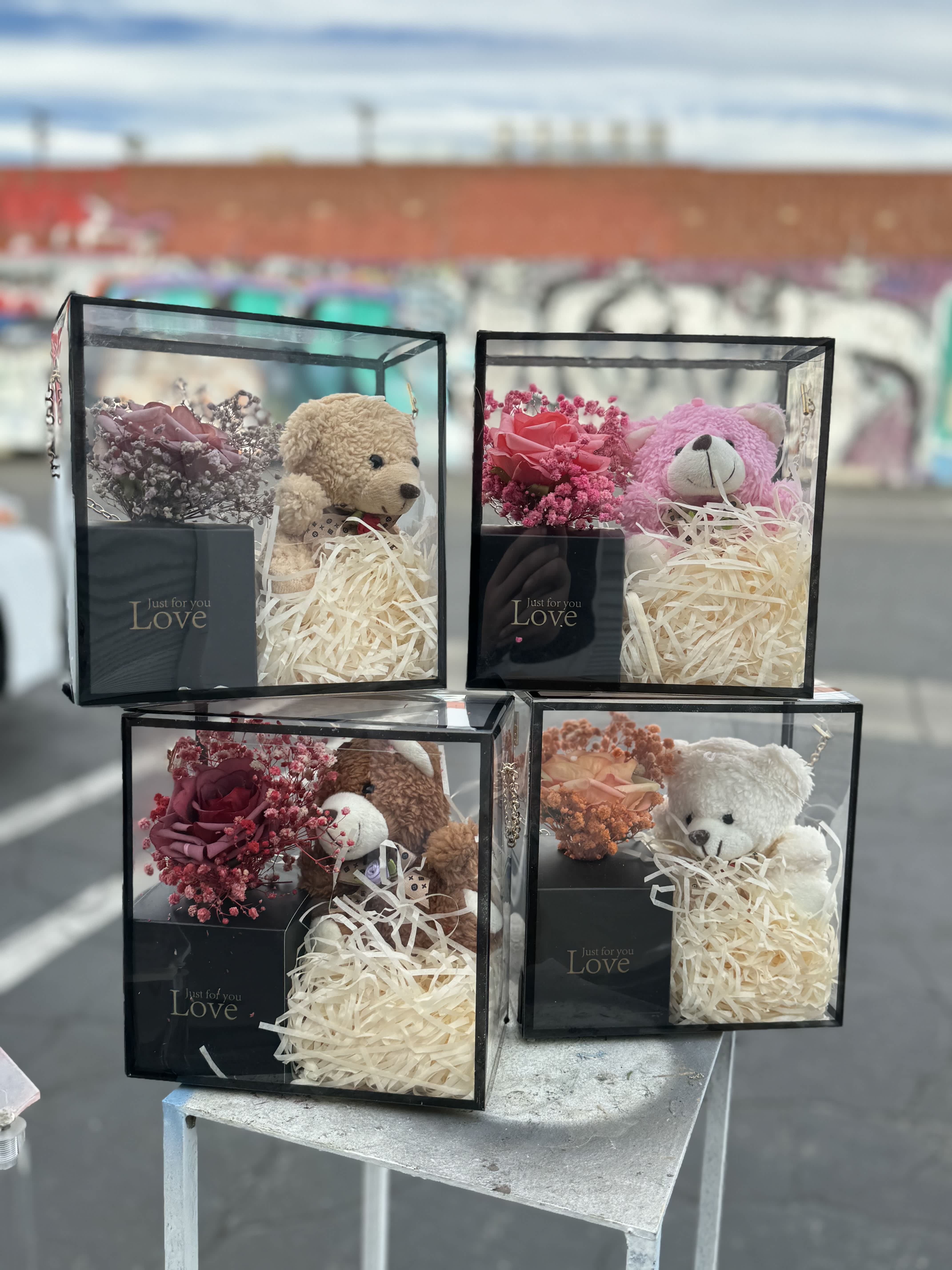 Gift boxes with teddy bears and small rose arrangements