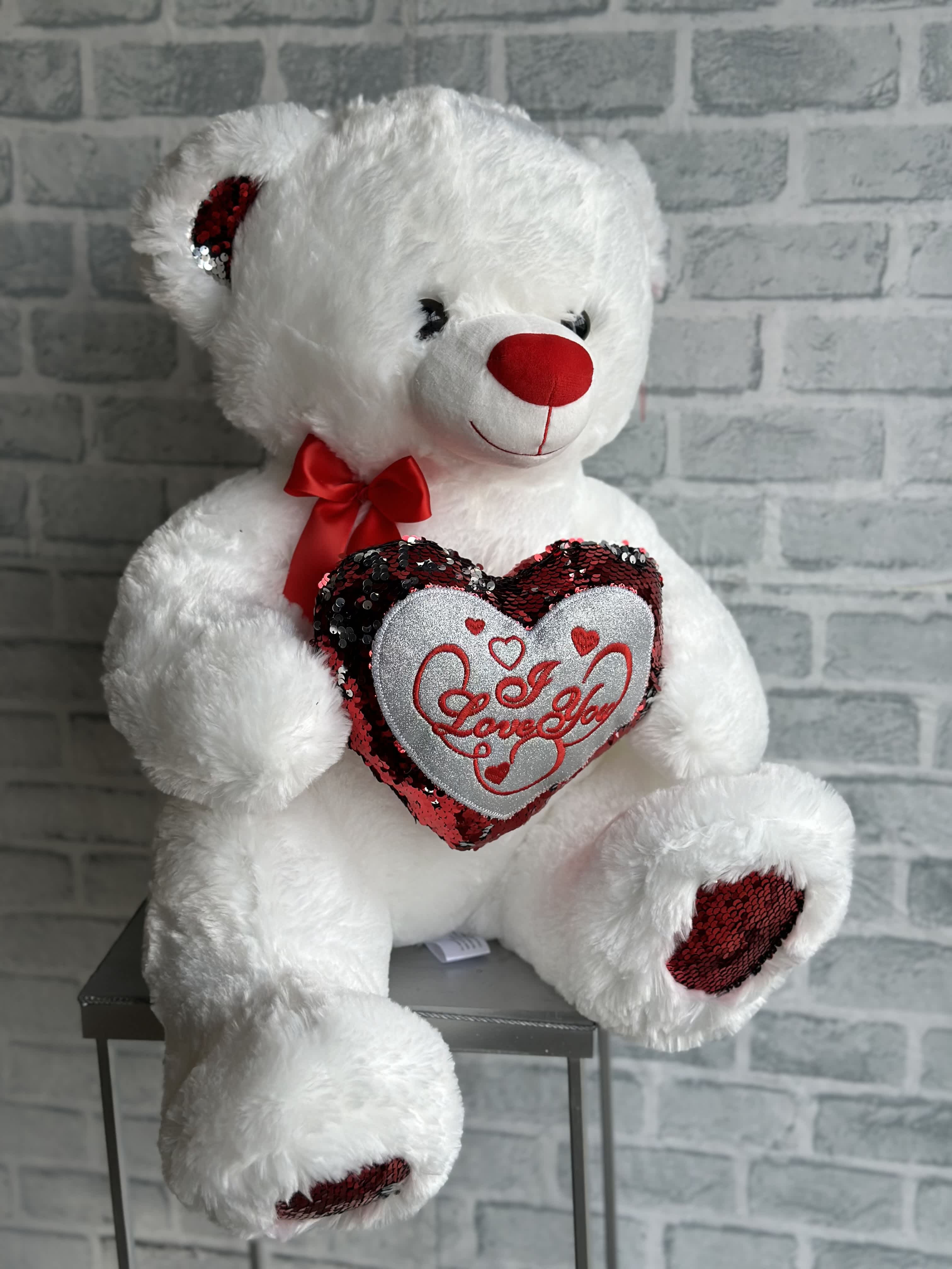 White teddy bear holding a heart with red sequins and "Love You" text