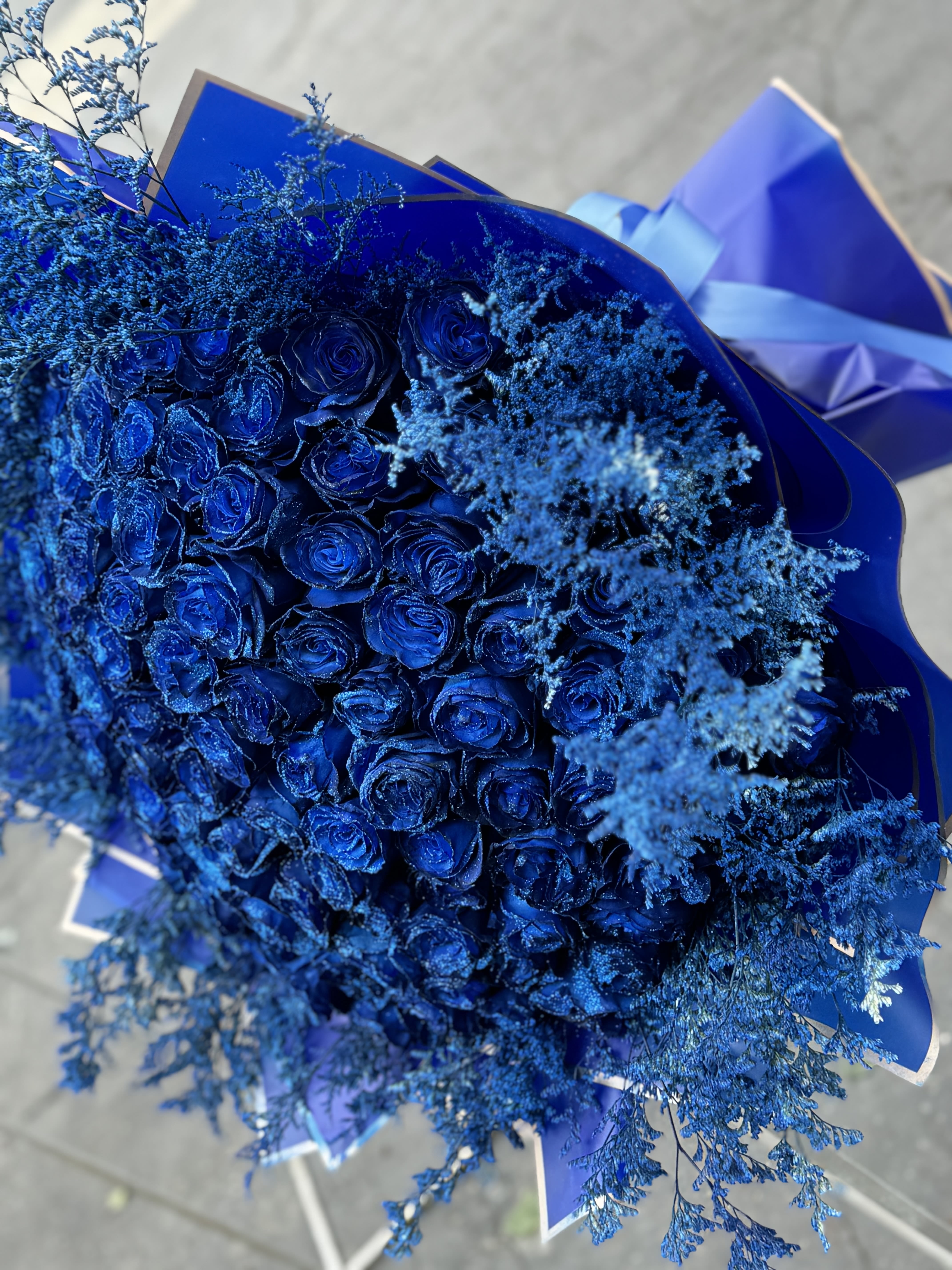 Bouquet of blue roses with airy blue filler