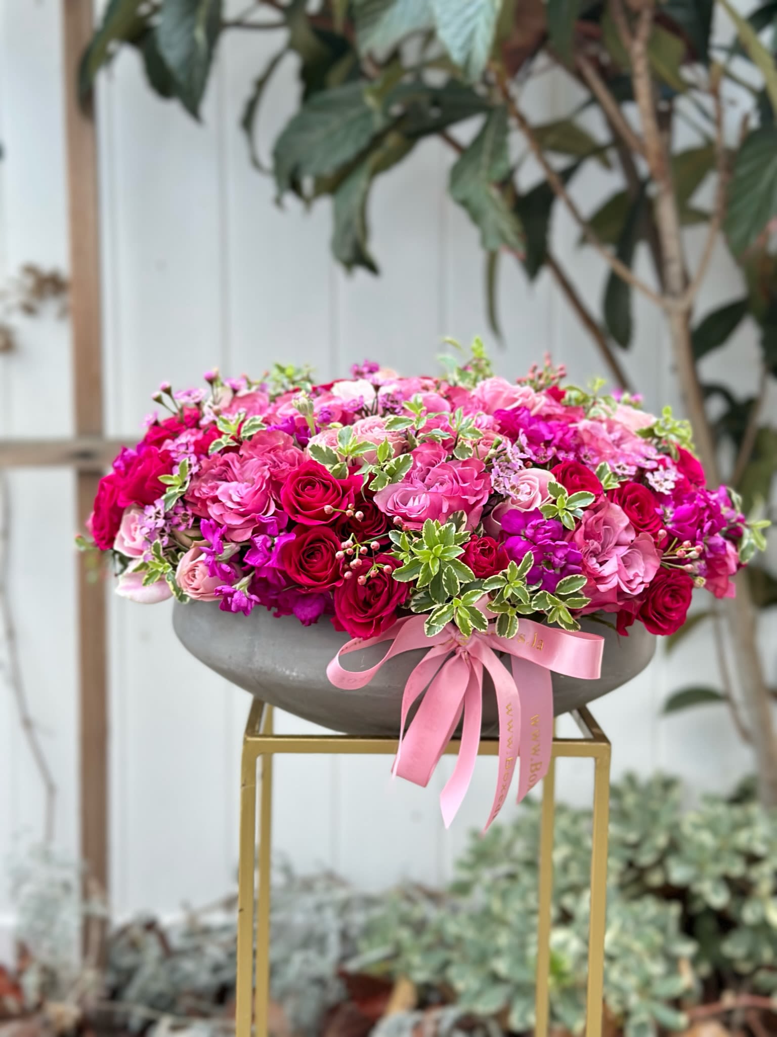 Cement vase mix - beautiful flat cement vase is filled with gorgeous hot pink, red, burgundy roses, spray roses and stock flower.  