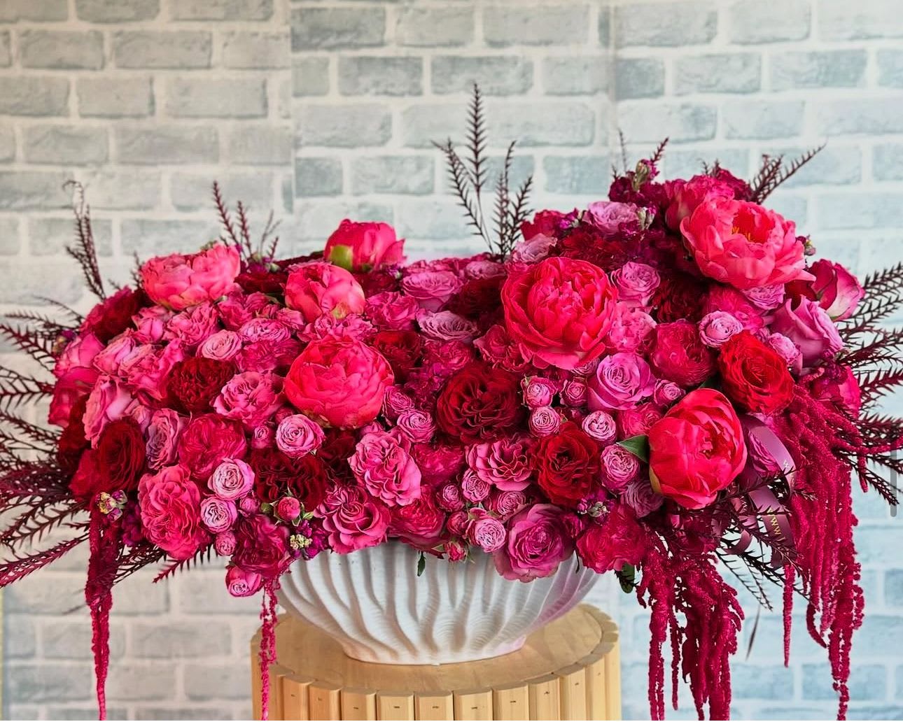 Fuchsia shades - Floral arrangement bursts with fuchsia shades.