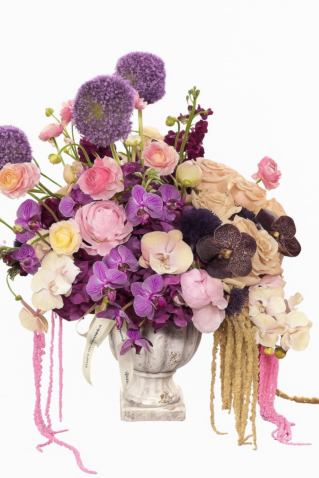 Lavender and pink floral arrangement in a pedestal vase