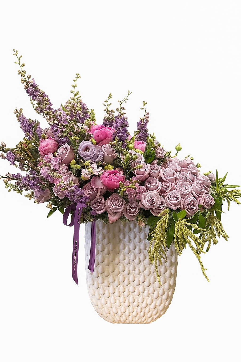 Lavender and pink floral arrangement in a textured cream vase