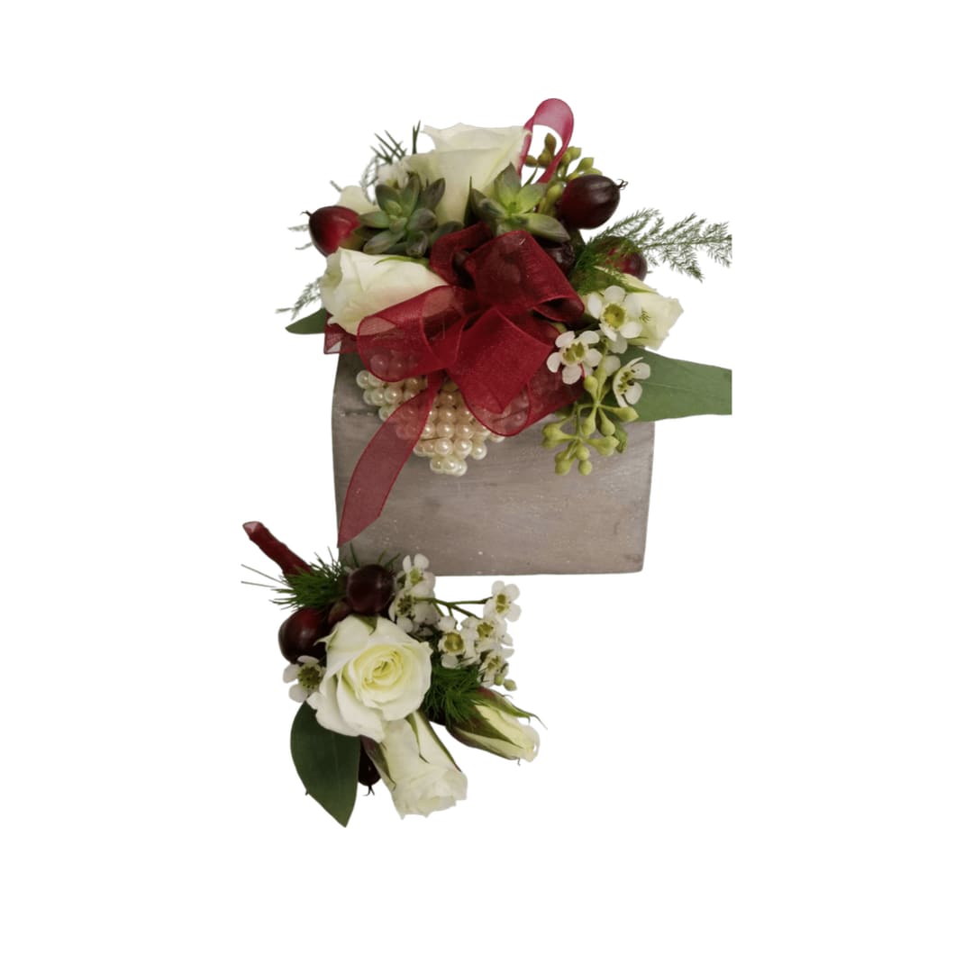 White rose arrangements with red ribbon and berries