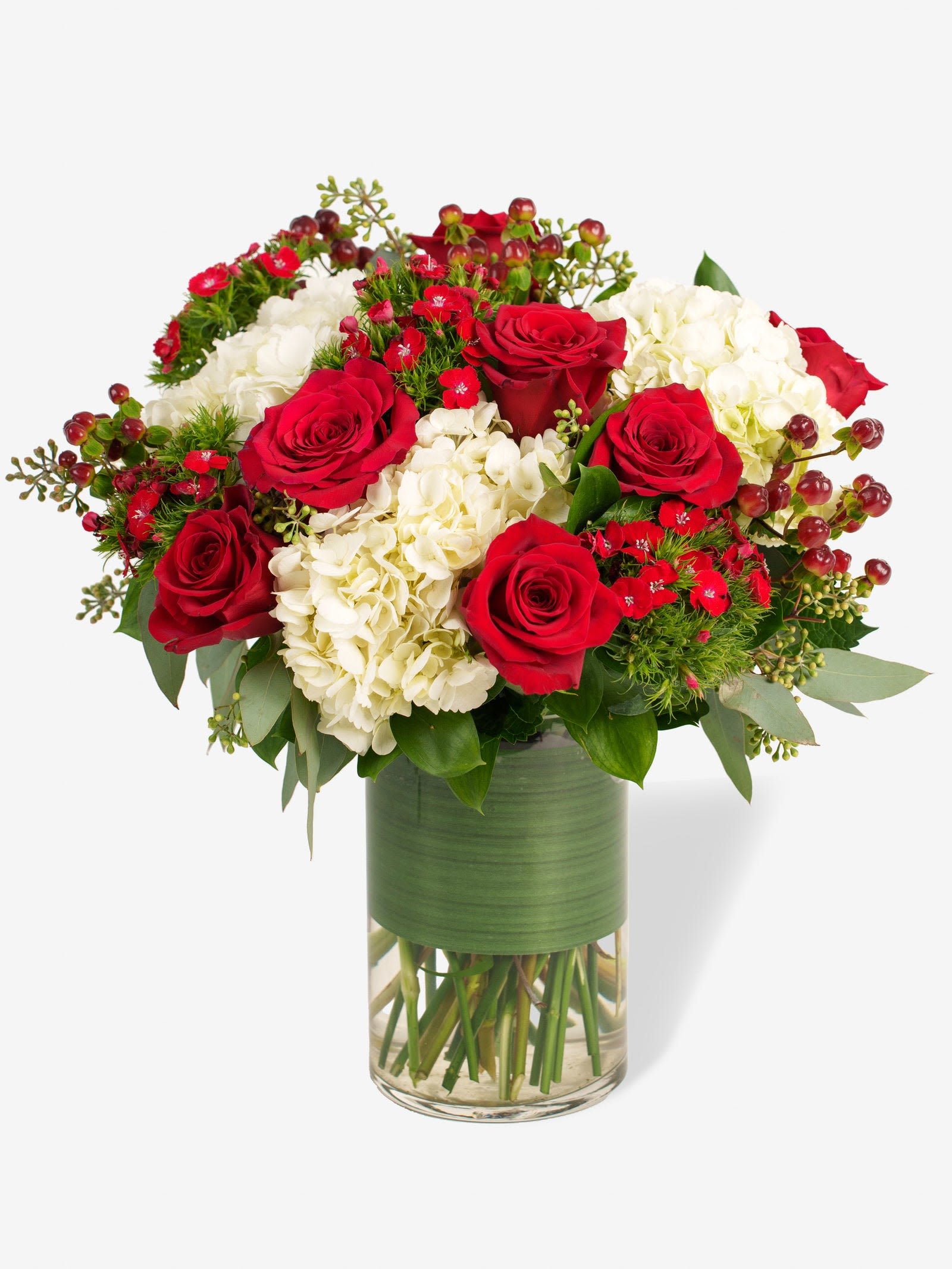 Red roses and white hydrangeas in a glass vase