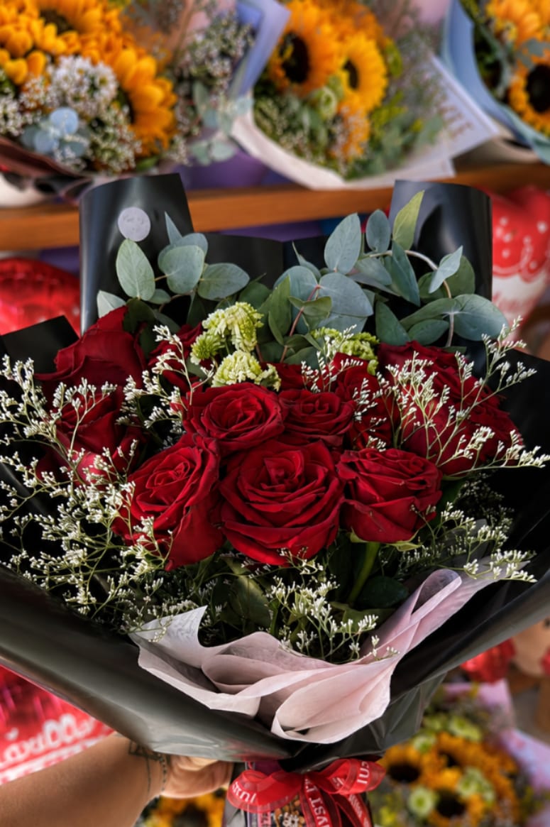 DATE NIGHT - The most iconic romantic gesture, elevated — a lush cluster of deep, velvety red roses nestled in delicate baby's breath, green button mums, and silver eucalyptus, all dramatically wrapped in matte black paper with a soft blush inner layer and a red "Just For You" satin ribbon. Pure, classic, and breathtakingly beautiful. This is the bouquet for the moments that matter most — Valentine's Day, anniversaries, proposals, or simply when you want to say "I love you" in the most unforgettable way possible. Timeless in every sense of the word.