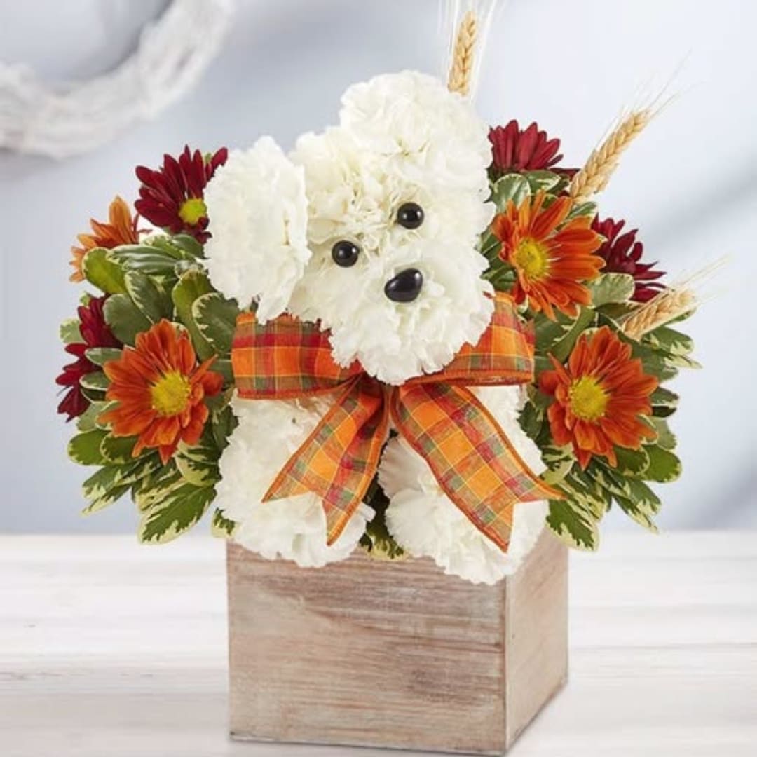 White teddy bear floral arrangement in a wooden box with orange ribbon