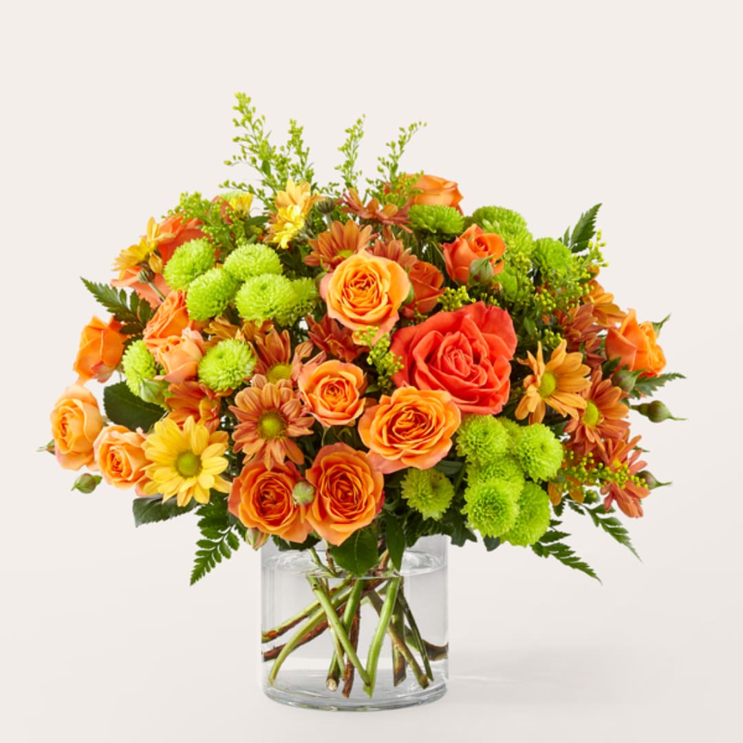 Orange and yellow flower bouquet in a clear glass vase
