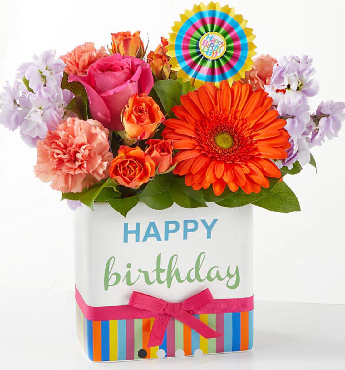 Birthday flower arrangement in a decorated gift box with a colorful topper