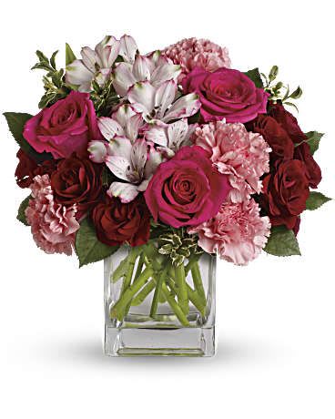 Pink and red bouquet in a clear glass vase