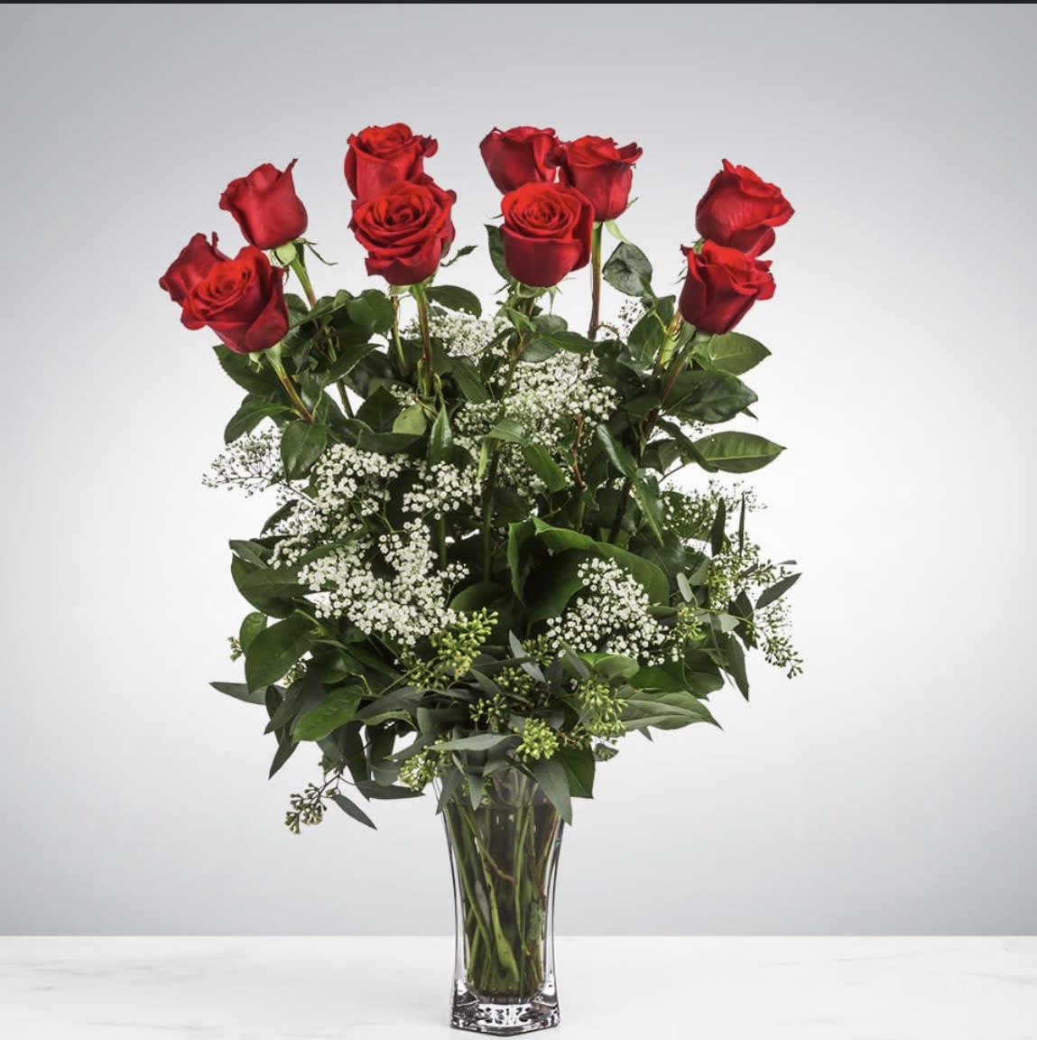 Dozen Long Stem Roses with Baby's Breath by BloomNation™ - These dozen red roses with baby's breath are classic! Perfect romantic gift for Valentine's Day or an Anniversary.   APPROXIMATE DIMENSIONS: 25" H X 18" W